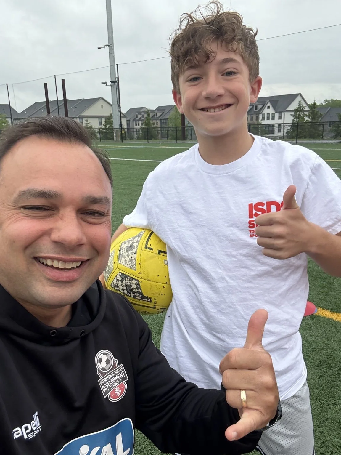 Arjun Dewan with a player on the training field
