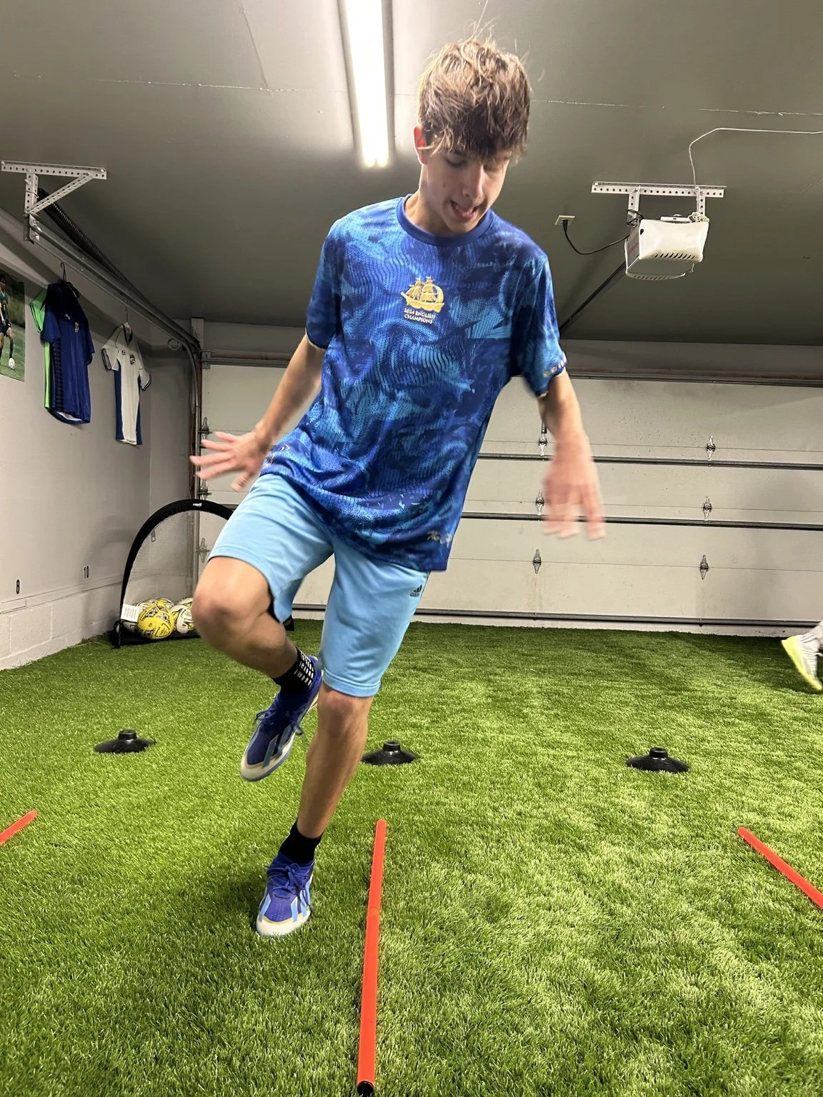 A young player working on agility during indoor soccer training