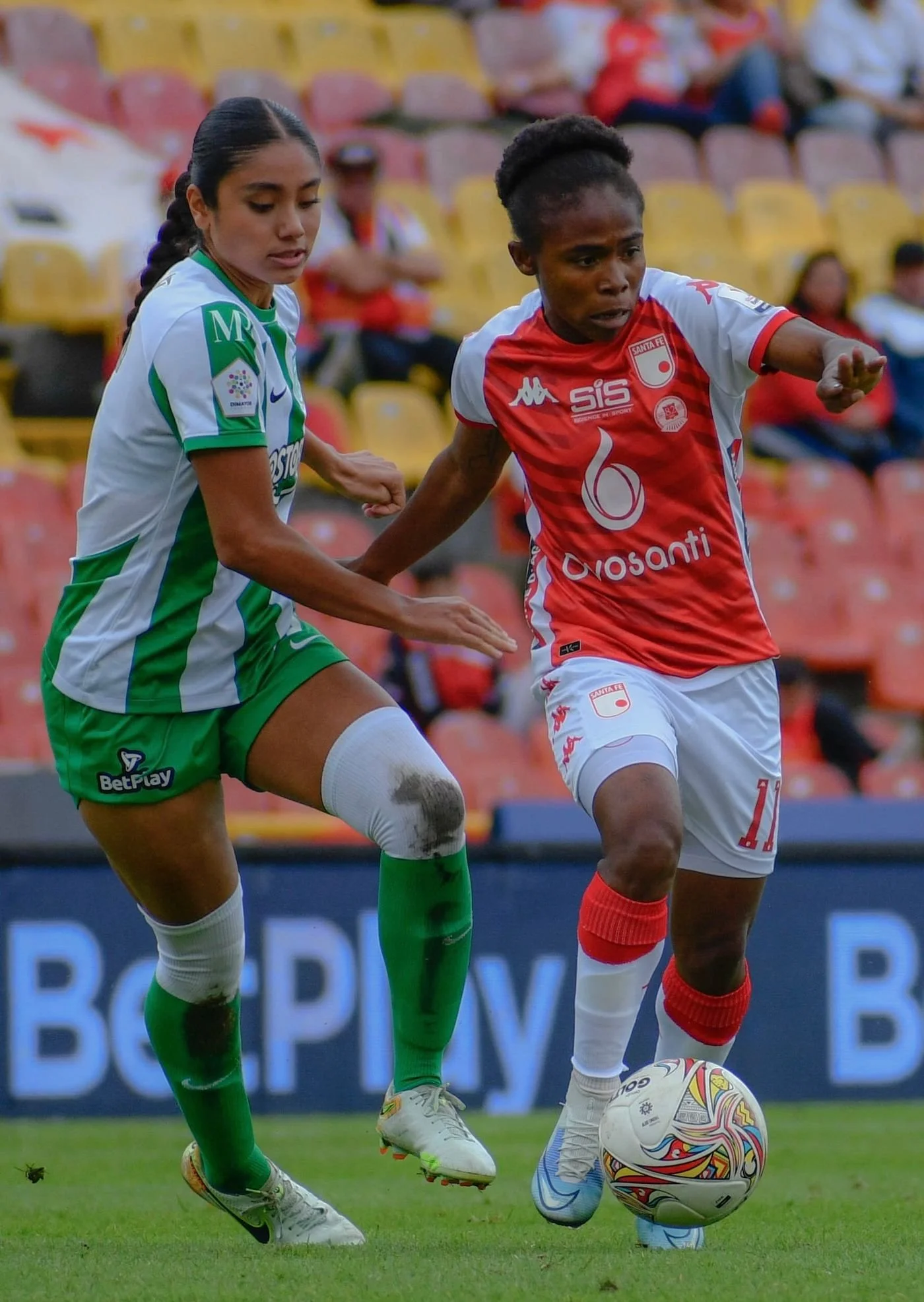 Women competing for the ball during a soccer match