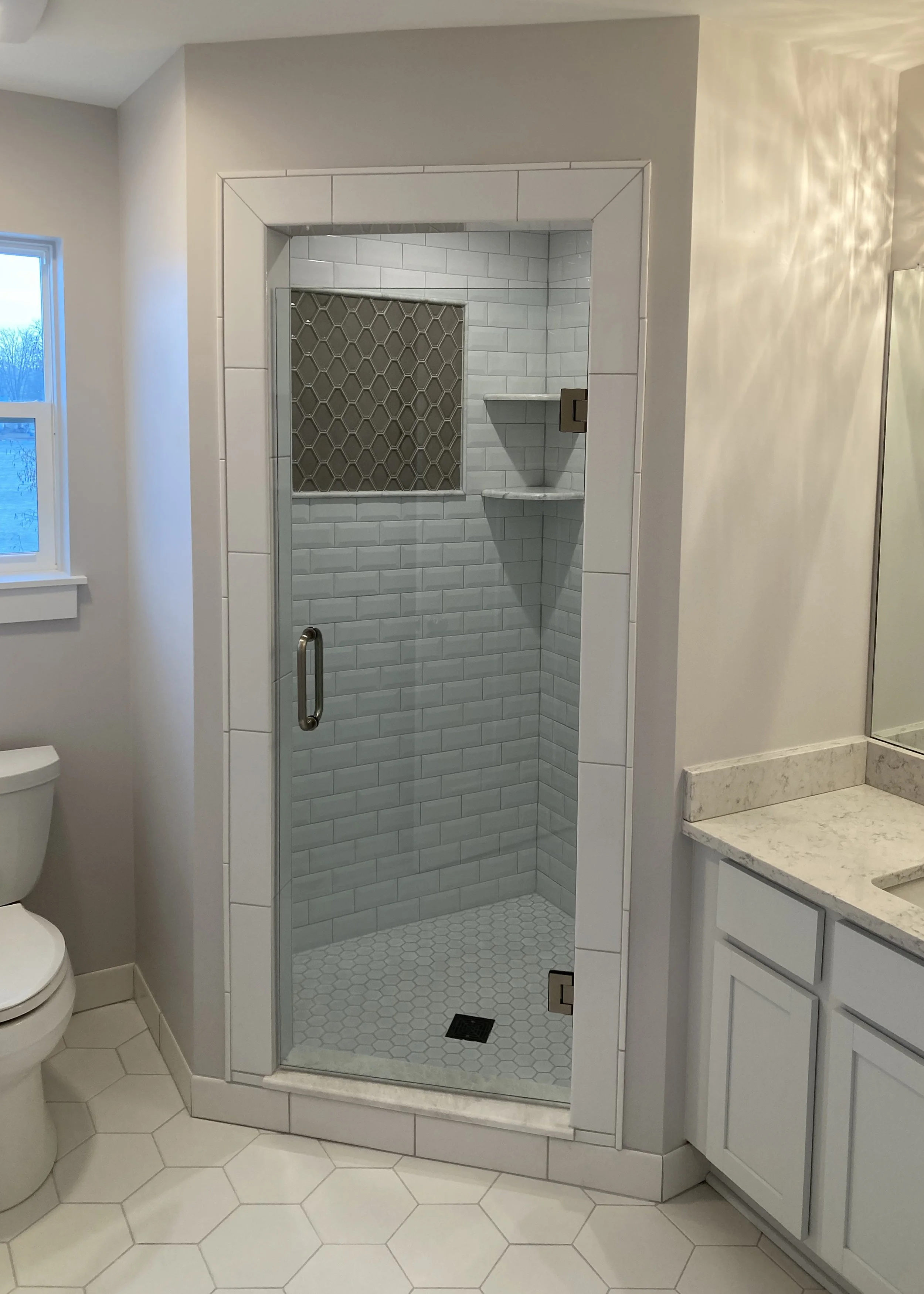 spacious corner shower with gorgeous tile combo