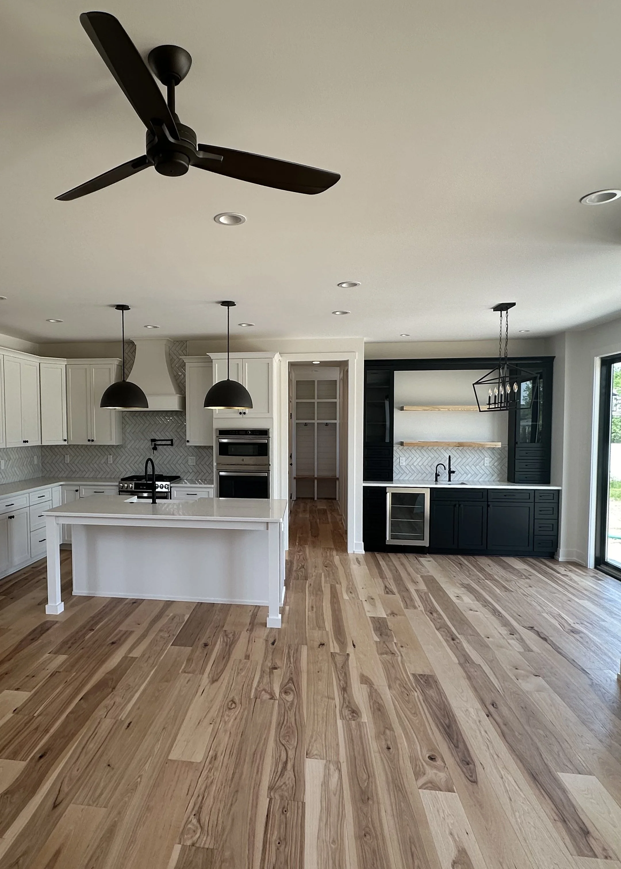 open concept family kitchen features a wetbar
