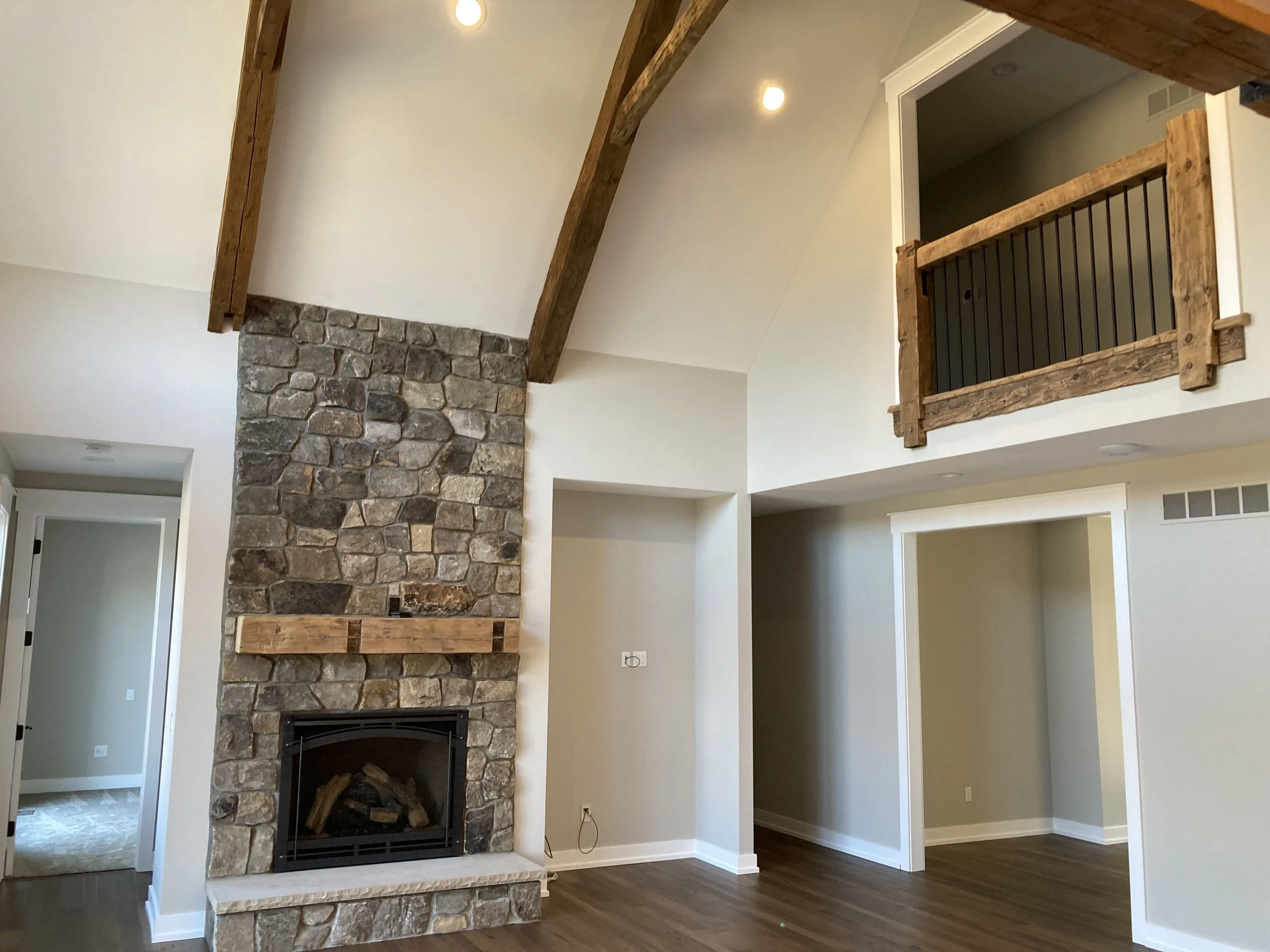 stunning great room is open to upstairs loft above