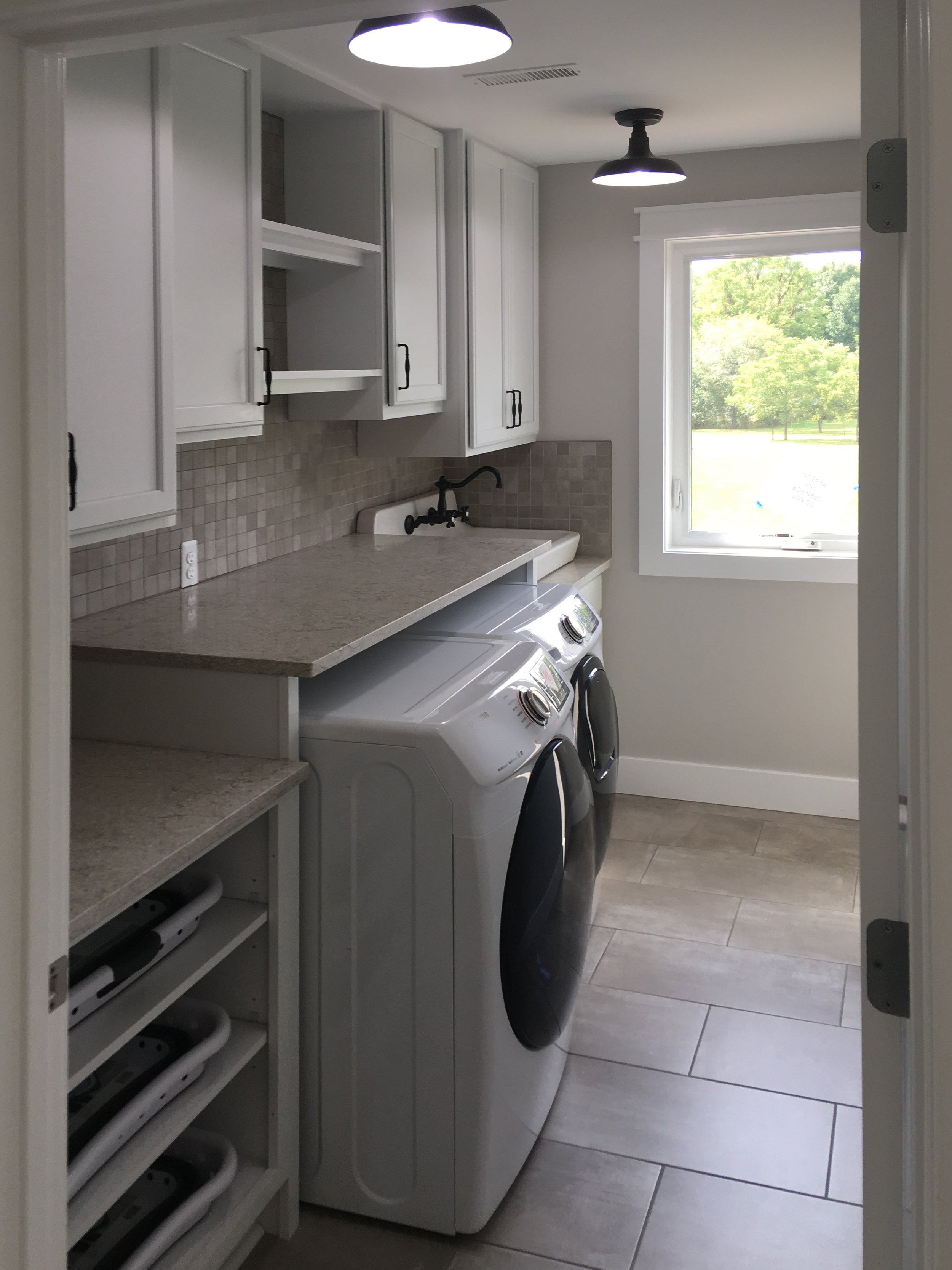 Stunning laundry room with built in folding spacae