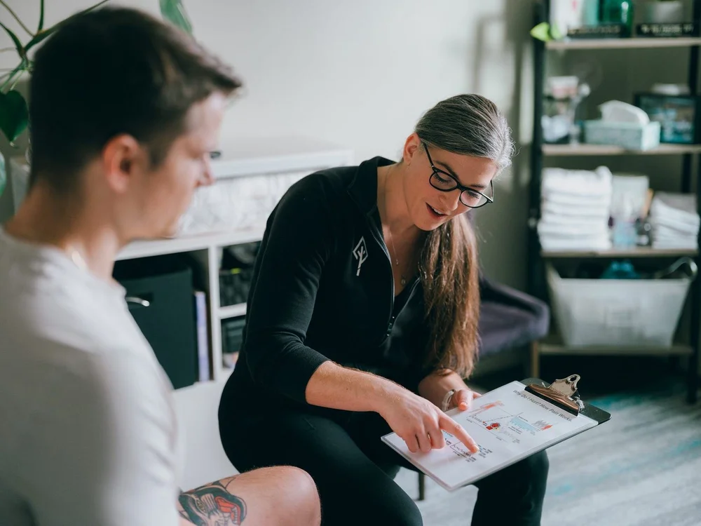 A physical therapist reviewing a plan of care with a patient