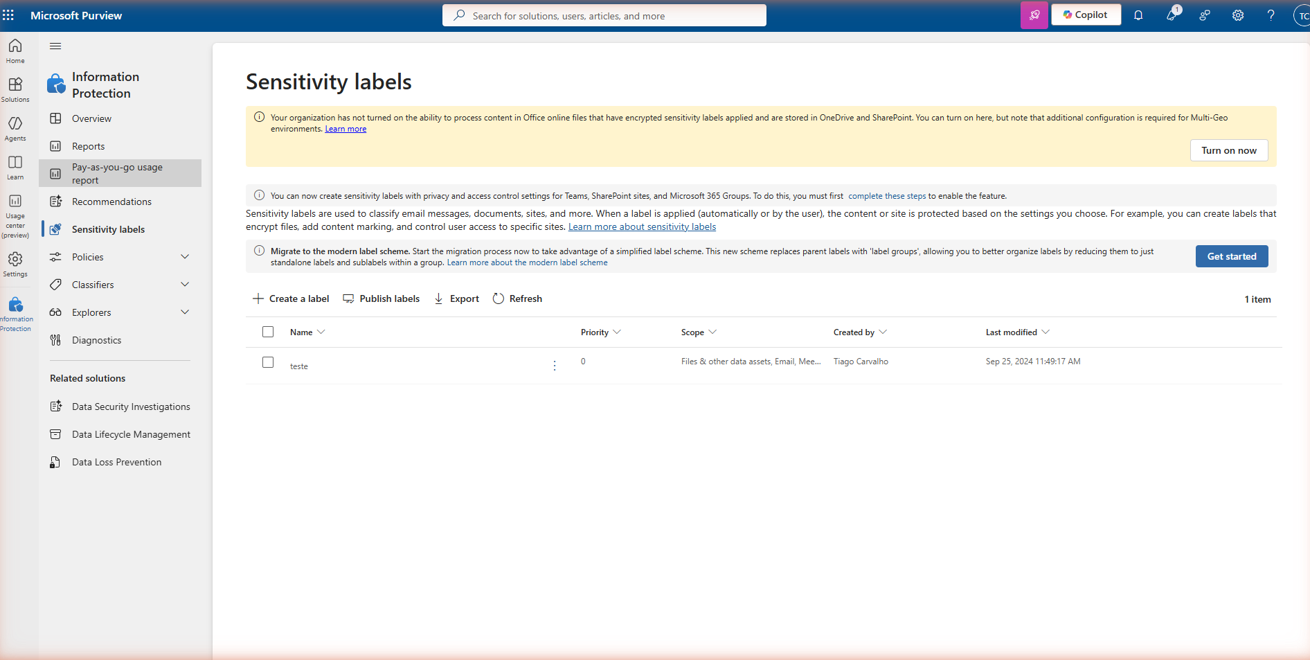 Microsoft Purview — Sensitivity labels overview page showing the yellow 'Turn on now' banner warning that the organisation has not turned on the ability to process content in Office online files with encrypted sensitivity labels stored in OneDrive and SharePoint.