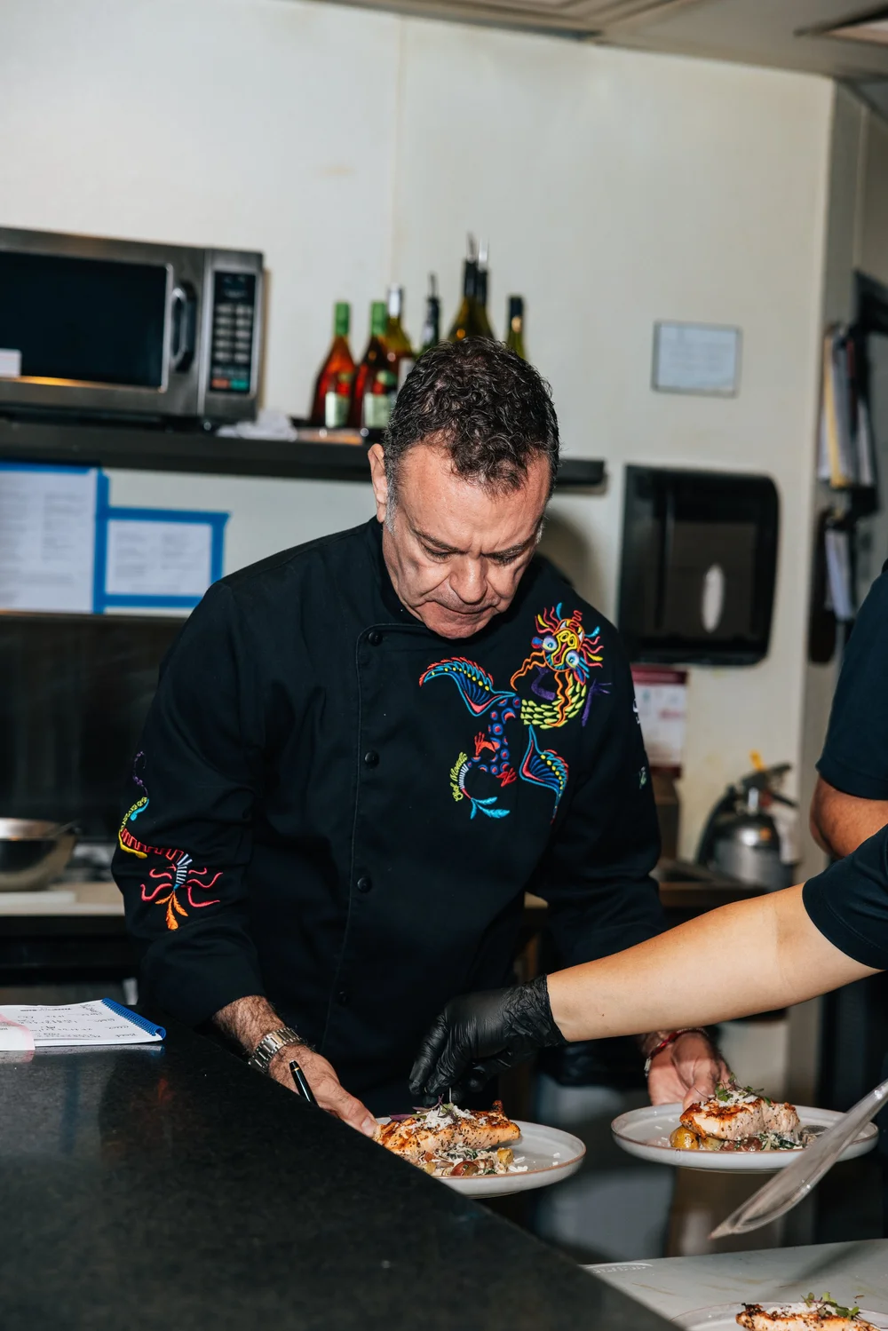 A chef plates dinner in the Salum kitchen.
