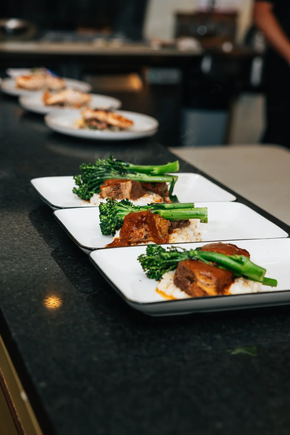 A row of plated dishes ready to serve at Salum.