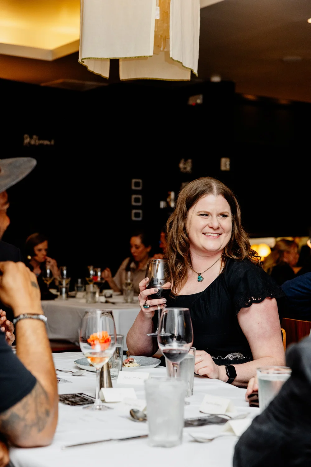 A smiling guest seated at the 2026 Salum dinner.
