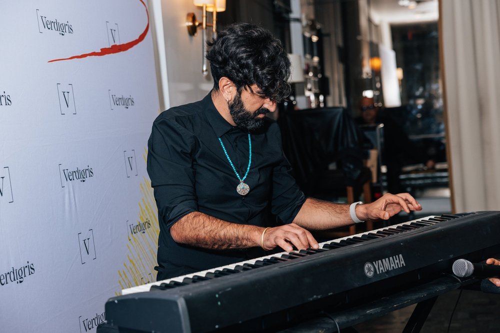 A musician plays keyboard at the Salum fundraiser.