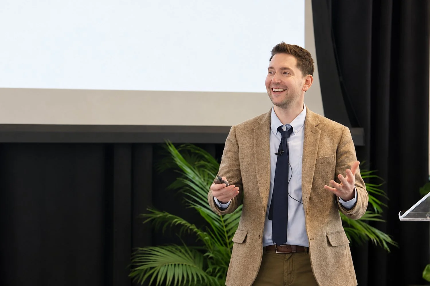 Dr. Aaron Dinin speaking on stage