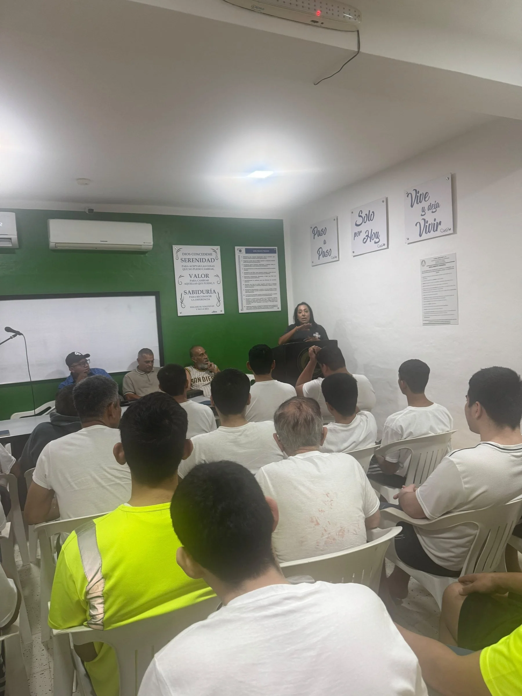 Volunteers seated in a classroom session before facility work