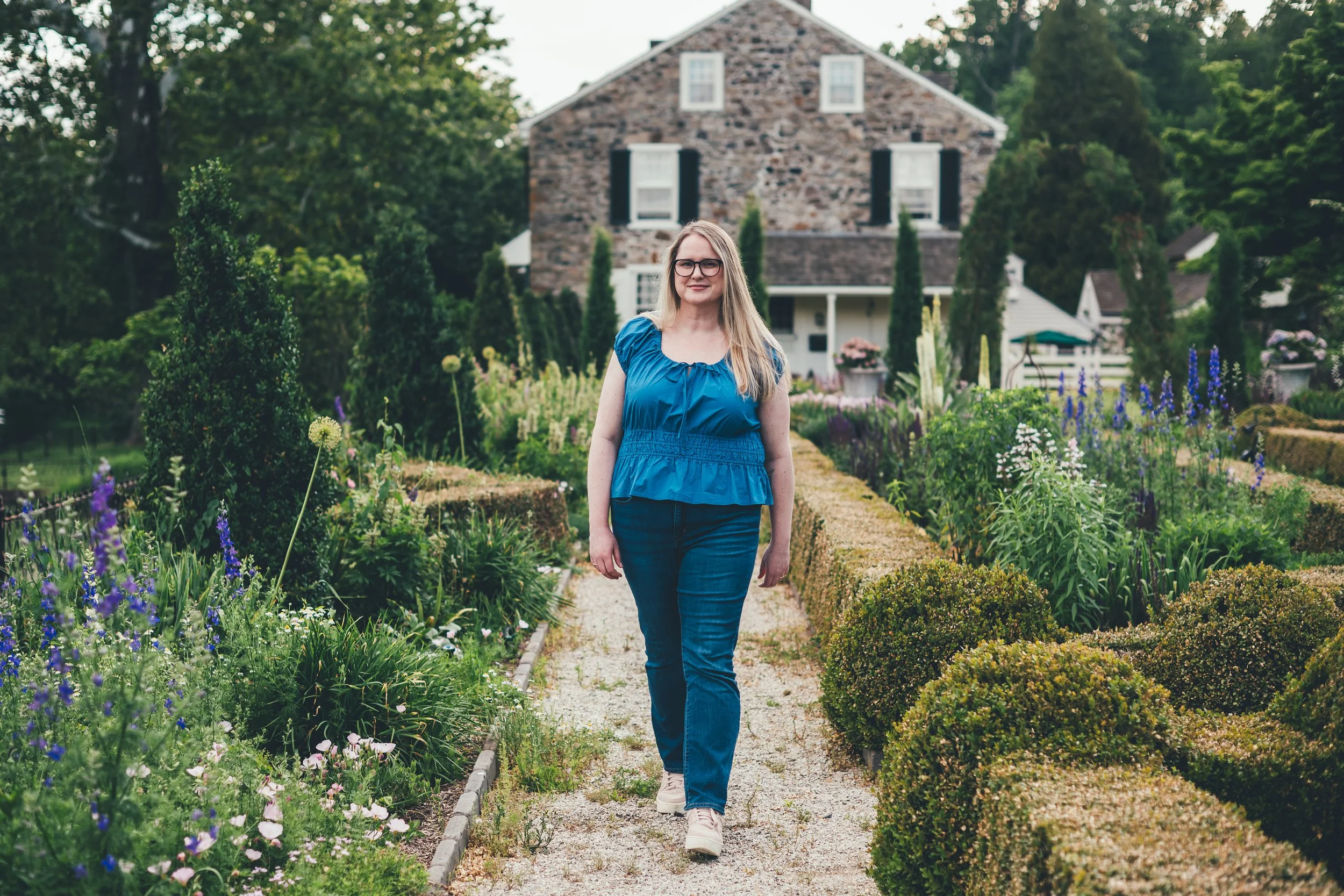Dr. Ashley Sutton, Psy.D., licensed clinical psychologist and founder of Bravewood Behavioral Health, smiling in a field of lavender. She specializes in burnout and anxiety therapy for high-achievers in New York and Pennsylvania.