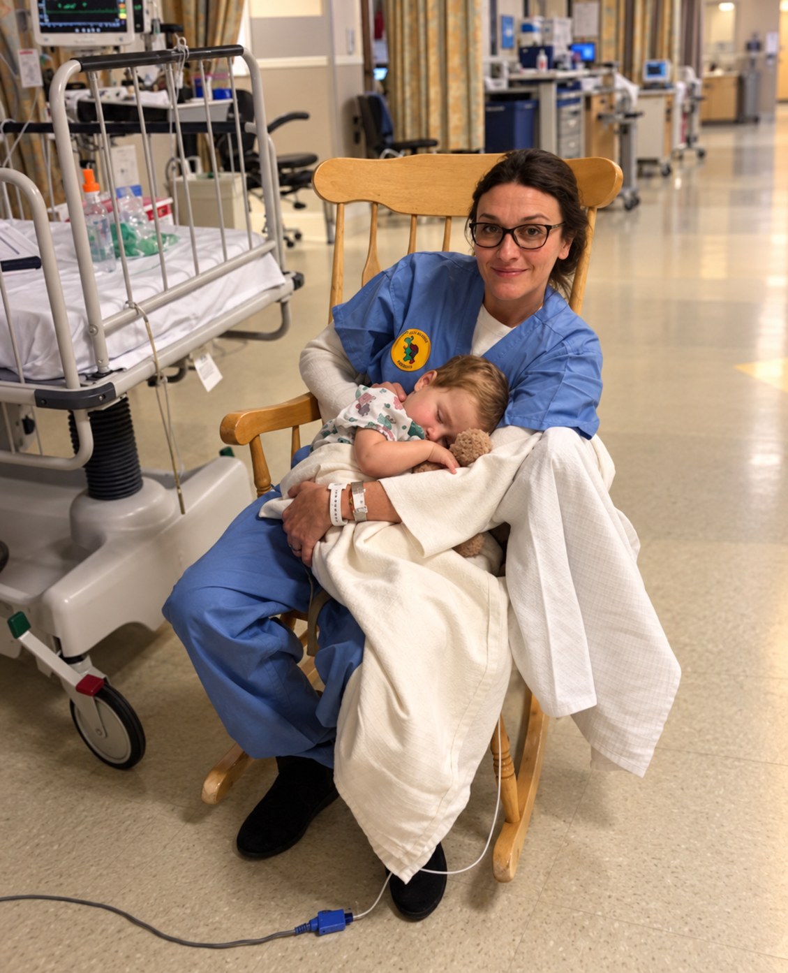 Laura holding Ellia, asleep, in a hospital rocking chair
