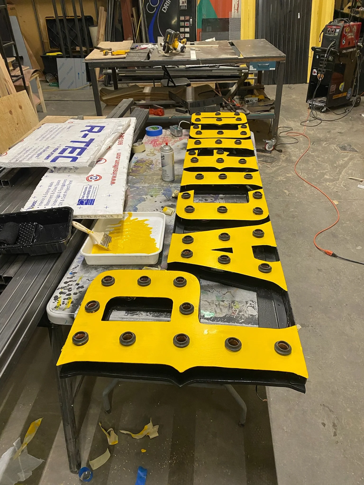 Painted fabrication pieces laid out in the shop