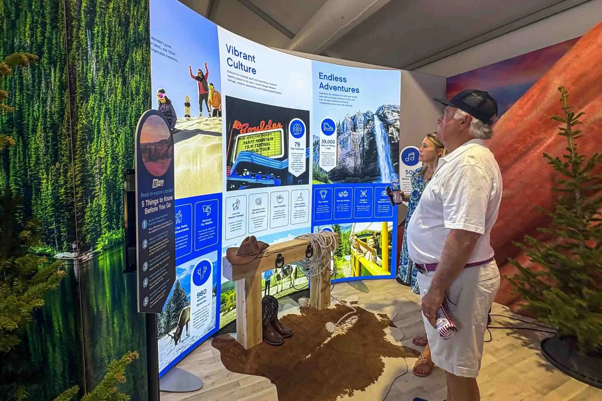 Visitors reading the Colorado culture and adventure wall