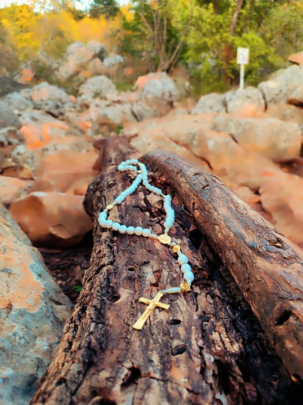 A rosary resting on the rocks of Apparition Hill
