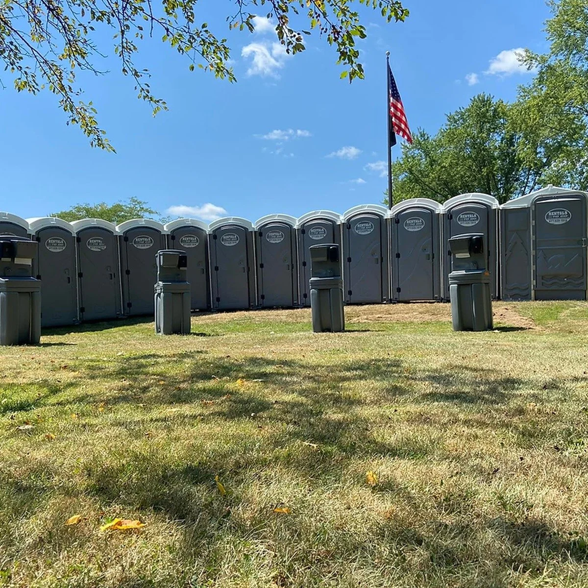 Portable toilets staged for workers at an active project for construction toilets and fencing services near me