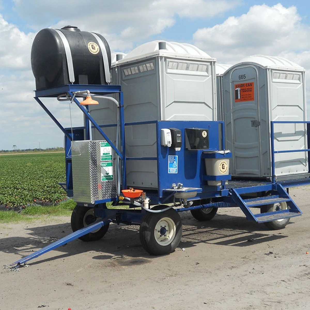 A temporary restroom trailer serving a longer-duration project for construction toilets and fencing near me in Pompano Beach, FL.