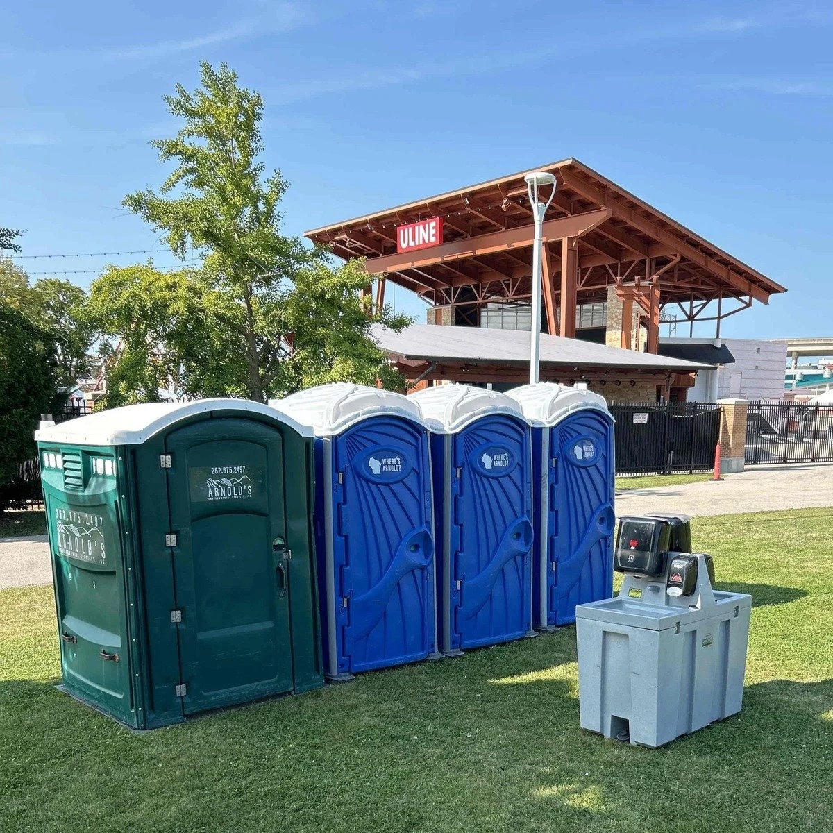 Portable toilets arranged near a temporary work area for construction toilets and fencing near me in Coconut Grove, FL.