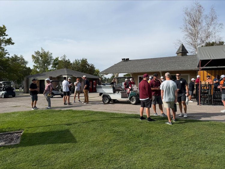 Players arriving at the clubhouse on golf carts
