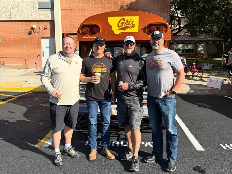 Former players in front of the Old School Griz bus at the GFPA tailgate
