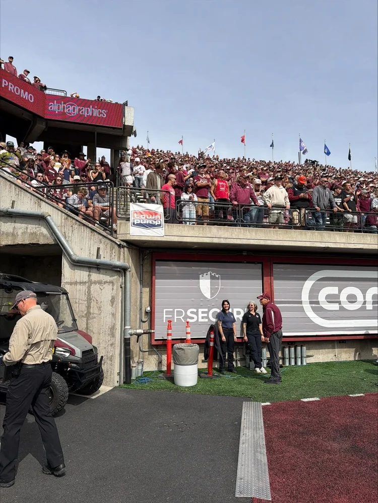 A packed student section above the stadium tunnel