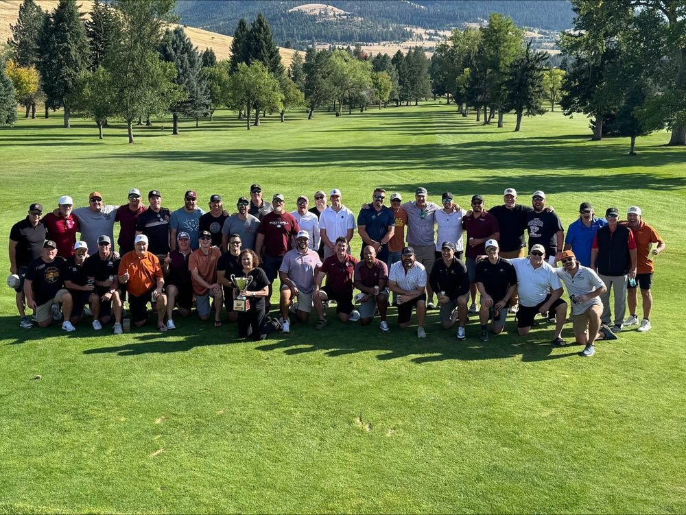 The full Hack field of former Griz players posed on the fairway at the University Golf Course
