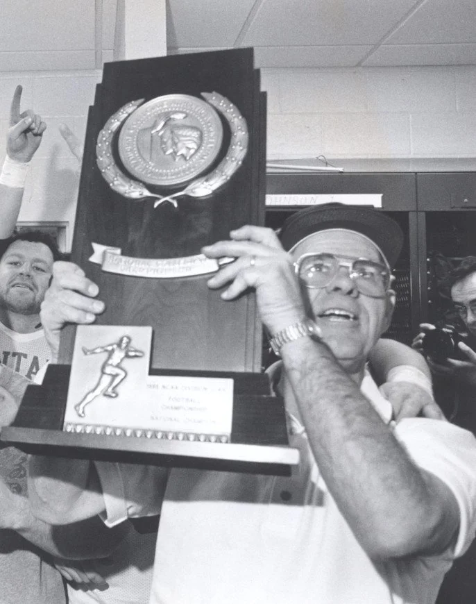 Coach Don Read raising the championship trophy
