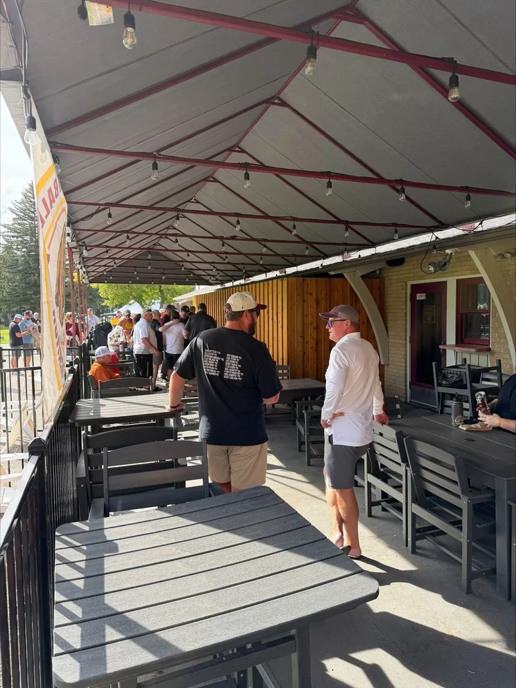 Two former players talking under the clubhouse porch lights