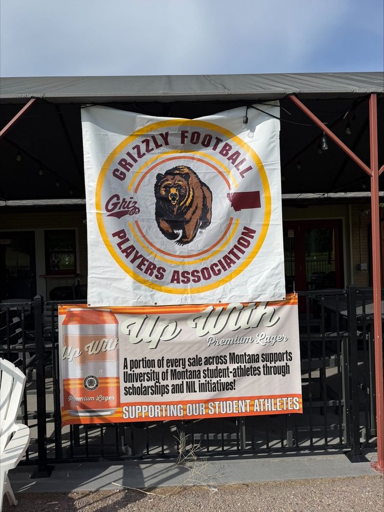 The Grizzly Football Players Association banner over the clubhouse rail