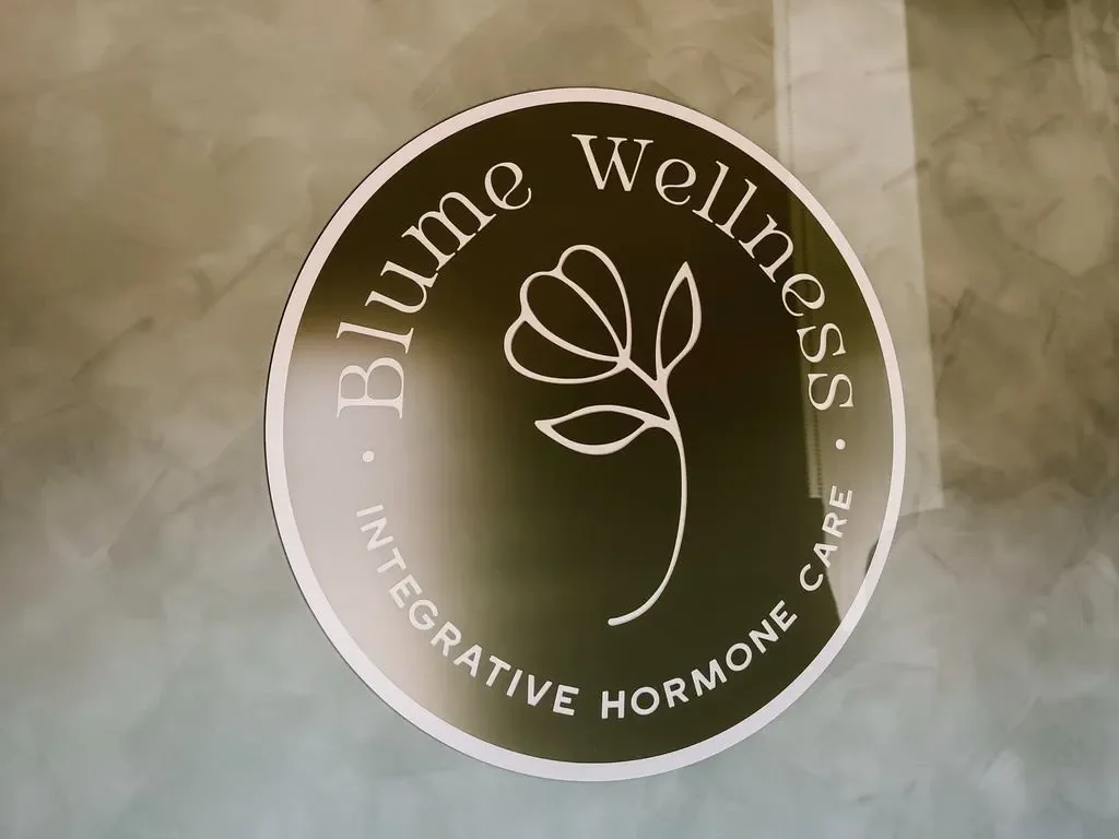 A Blume Wellness logo on the wall