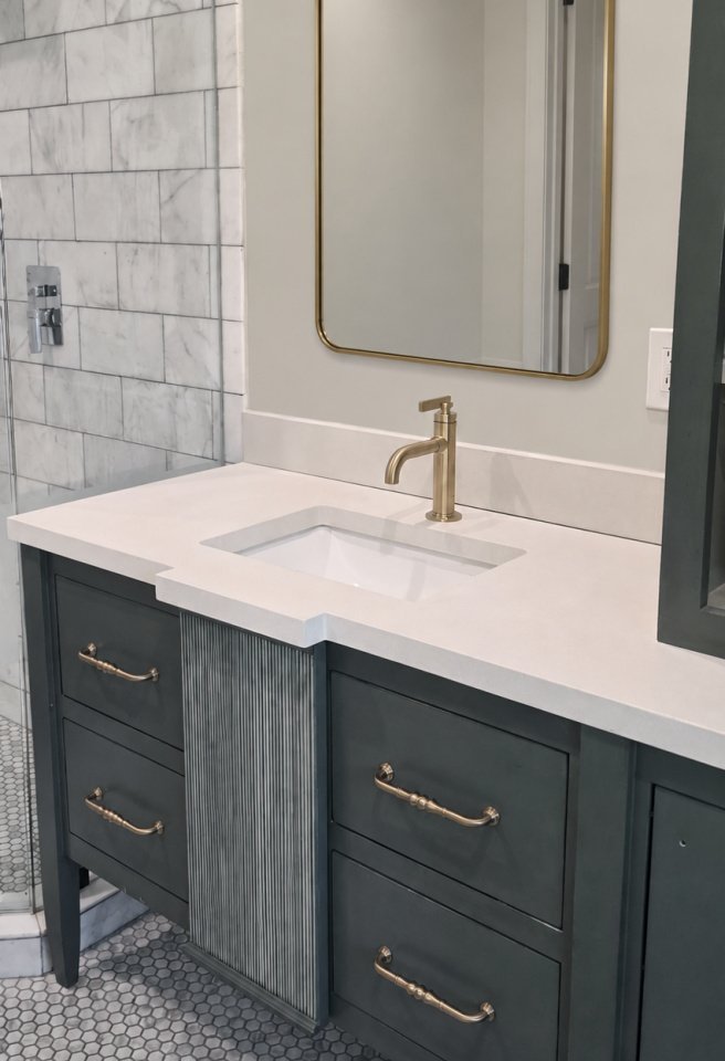 White concrete vanity top paired with an undermount basin and dark cabinetry