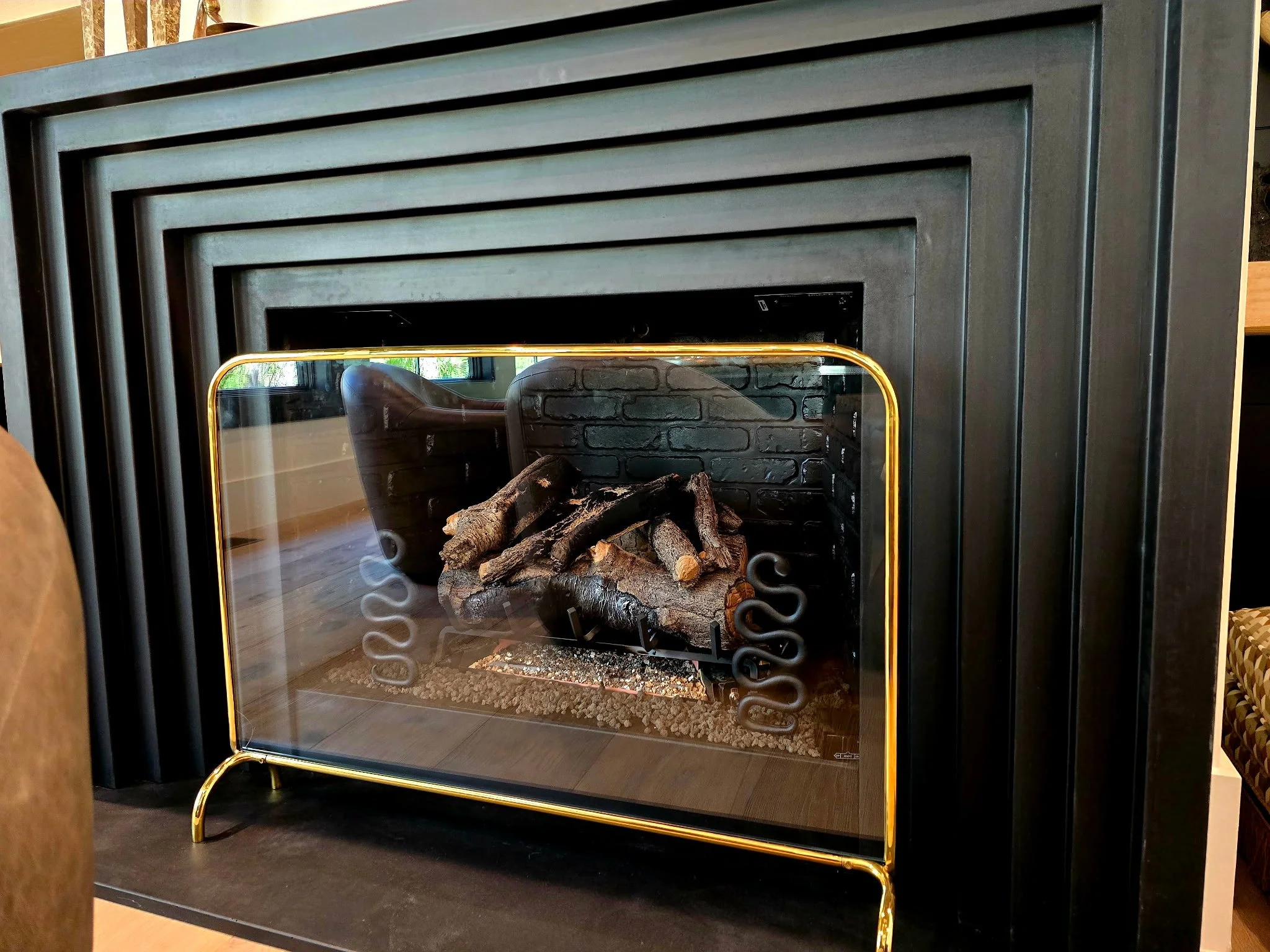 Close-up of the stepped black Blackline fireplace surround
