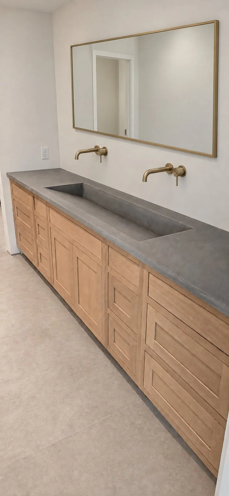 Extended ramp sink with integrated countertop installed over wood cabinetry
