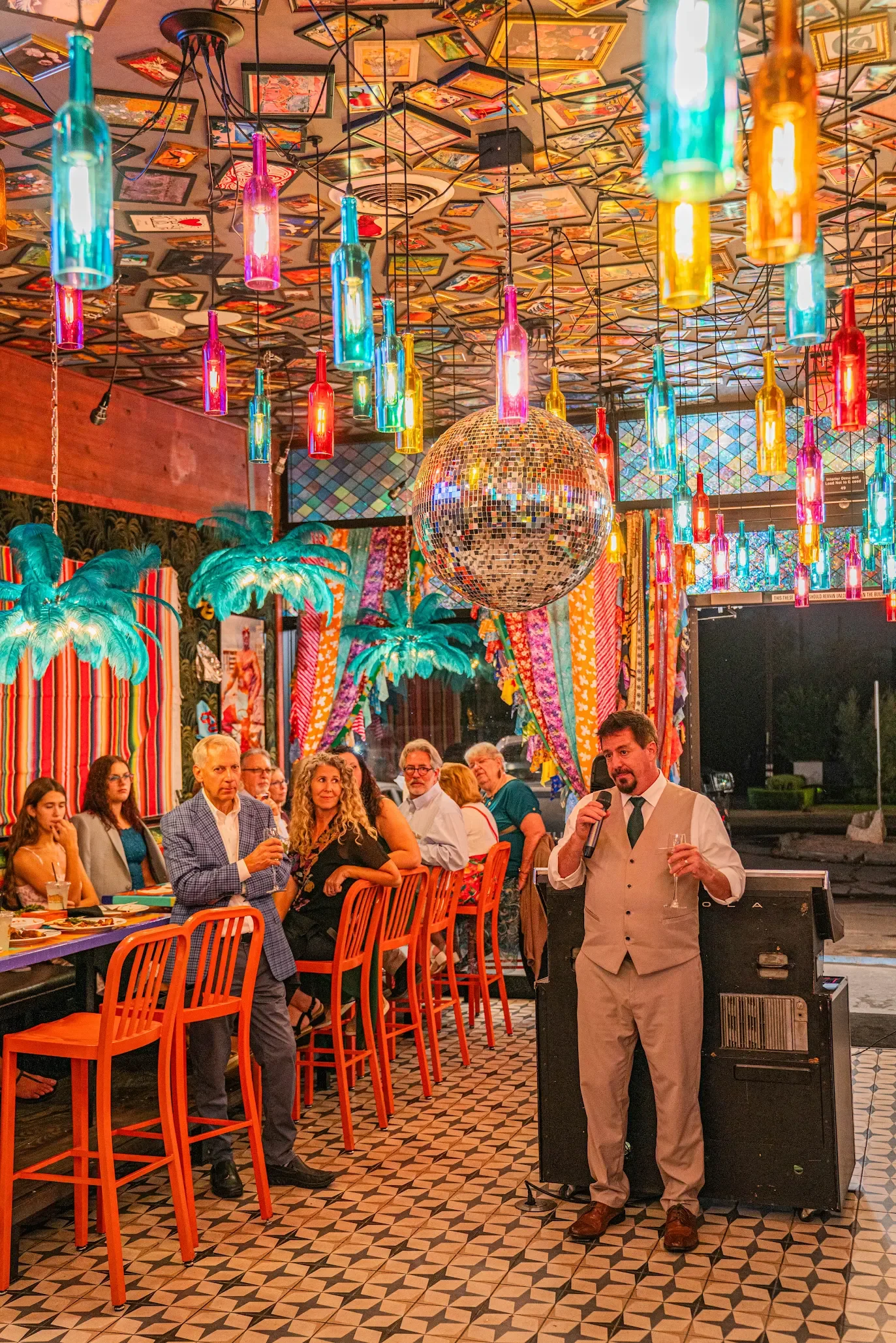 A celebration at Funky Frida's, guests gathered under string lights and a disco ball