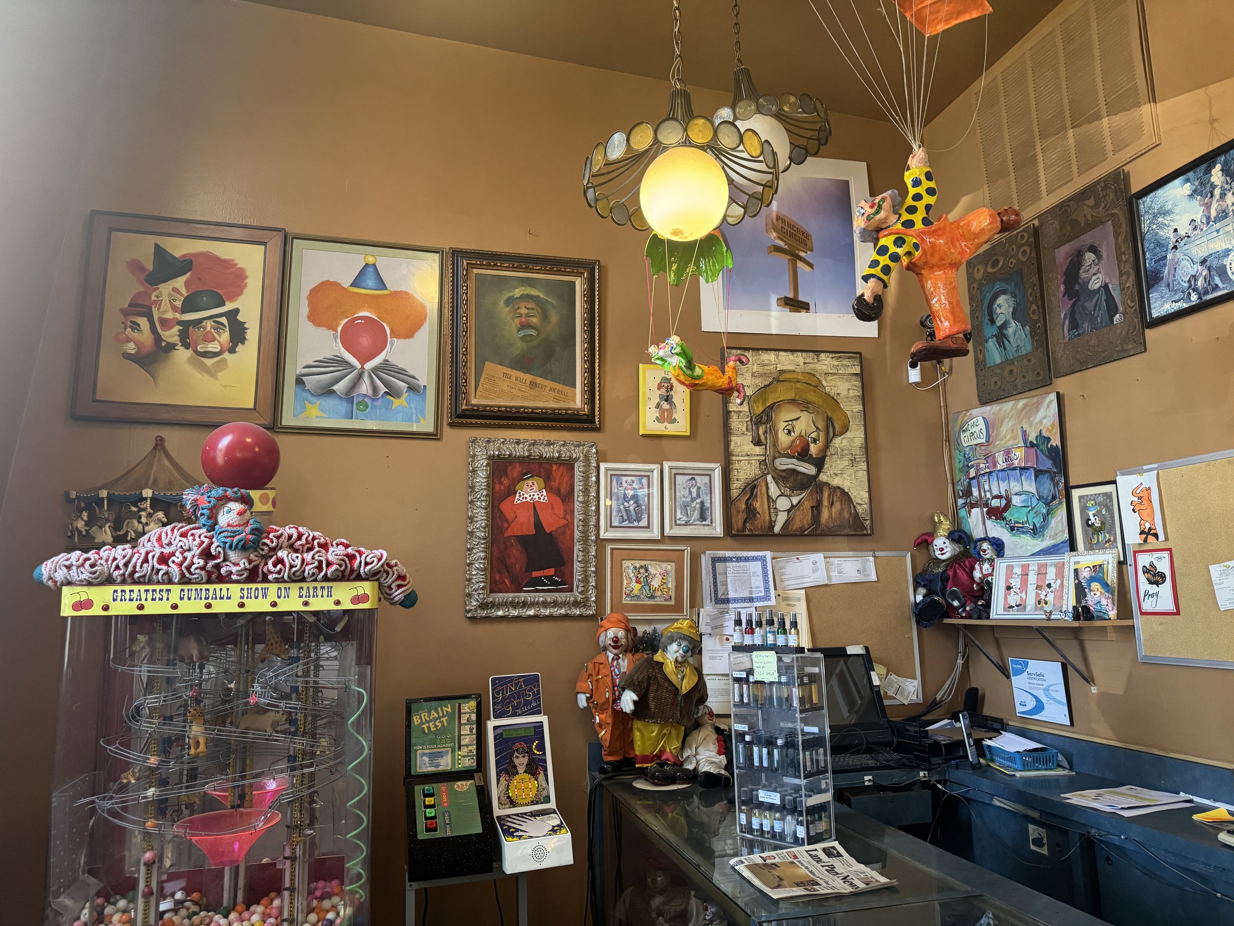Eclectic collection of clown paintings, dolls, and circus memorabilia inside Pancake Circus in Sacramento.