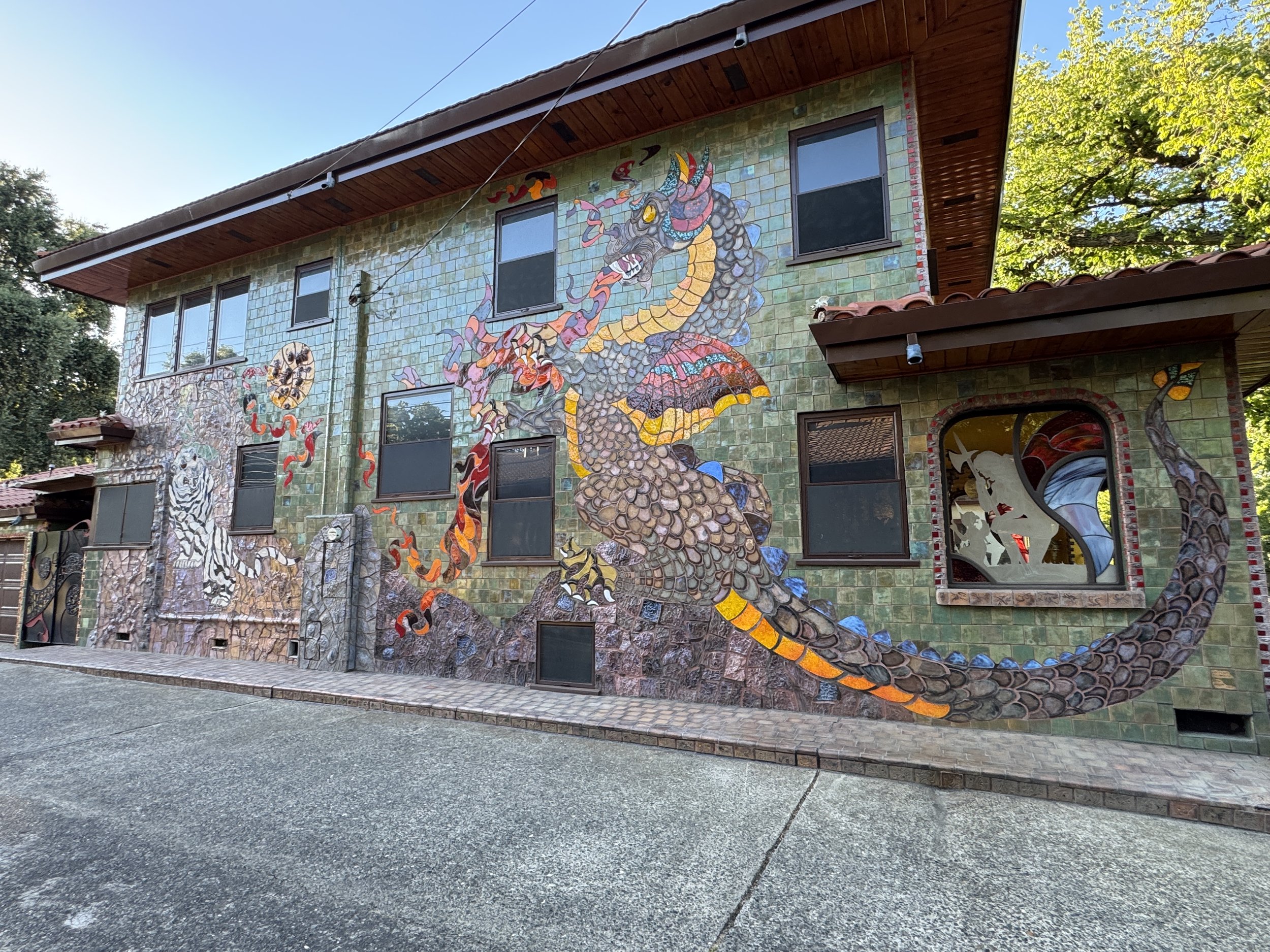 Large colorful dragon mosaic covering the side of the Dragon House in Sacramento.
