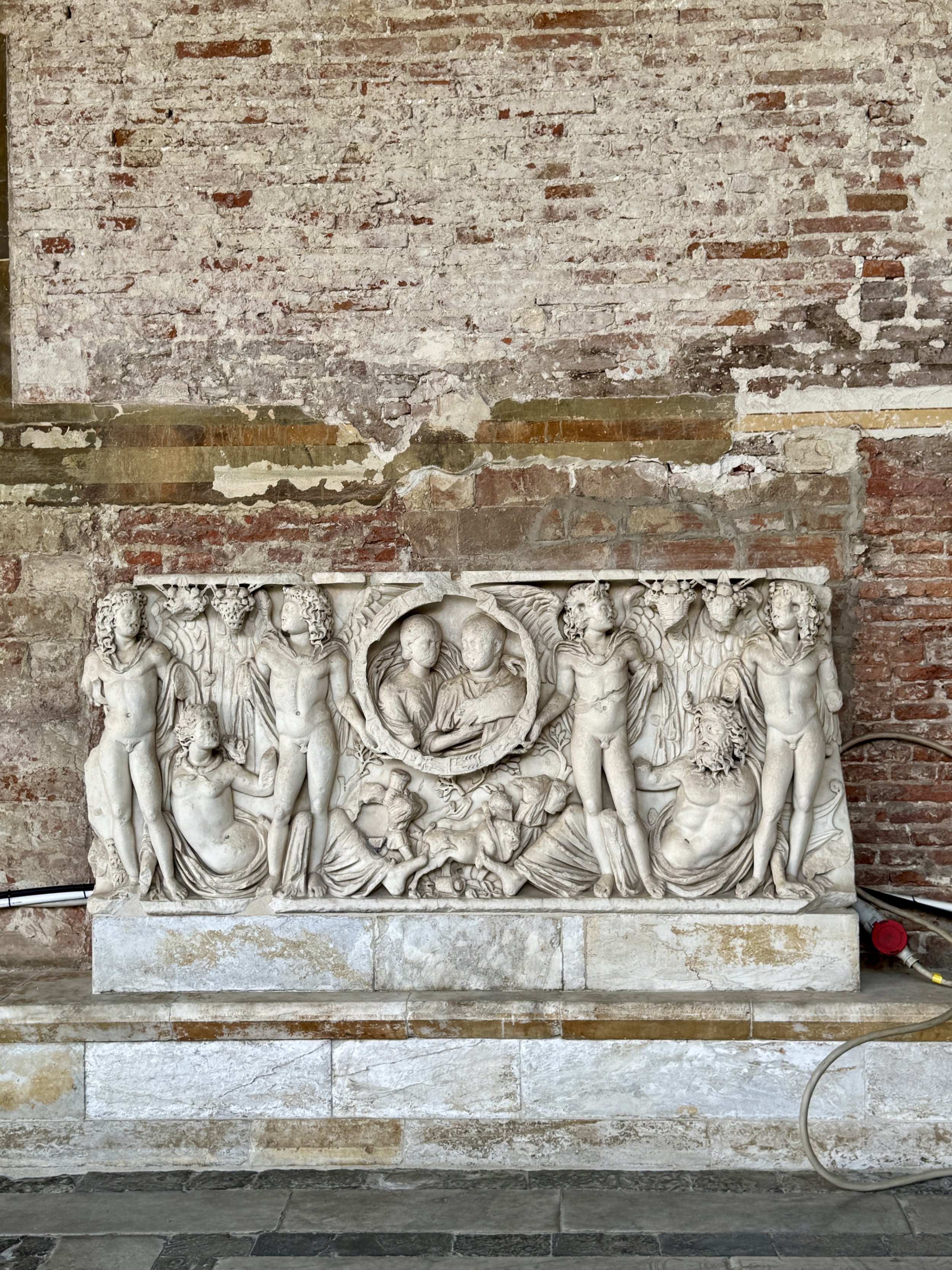 Roman marble sarcophagus carved with mythological figures inside Camposanto Monumentale.