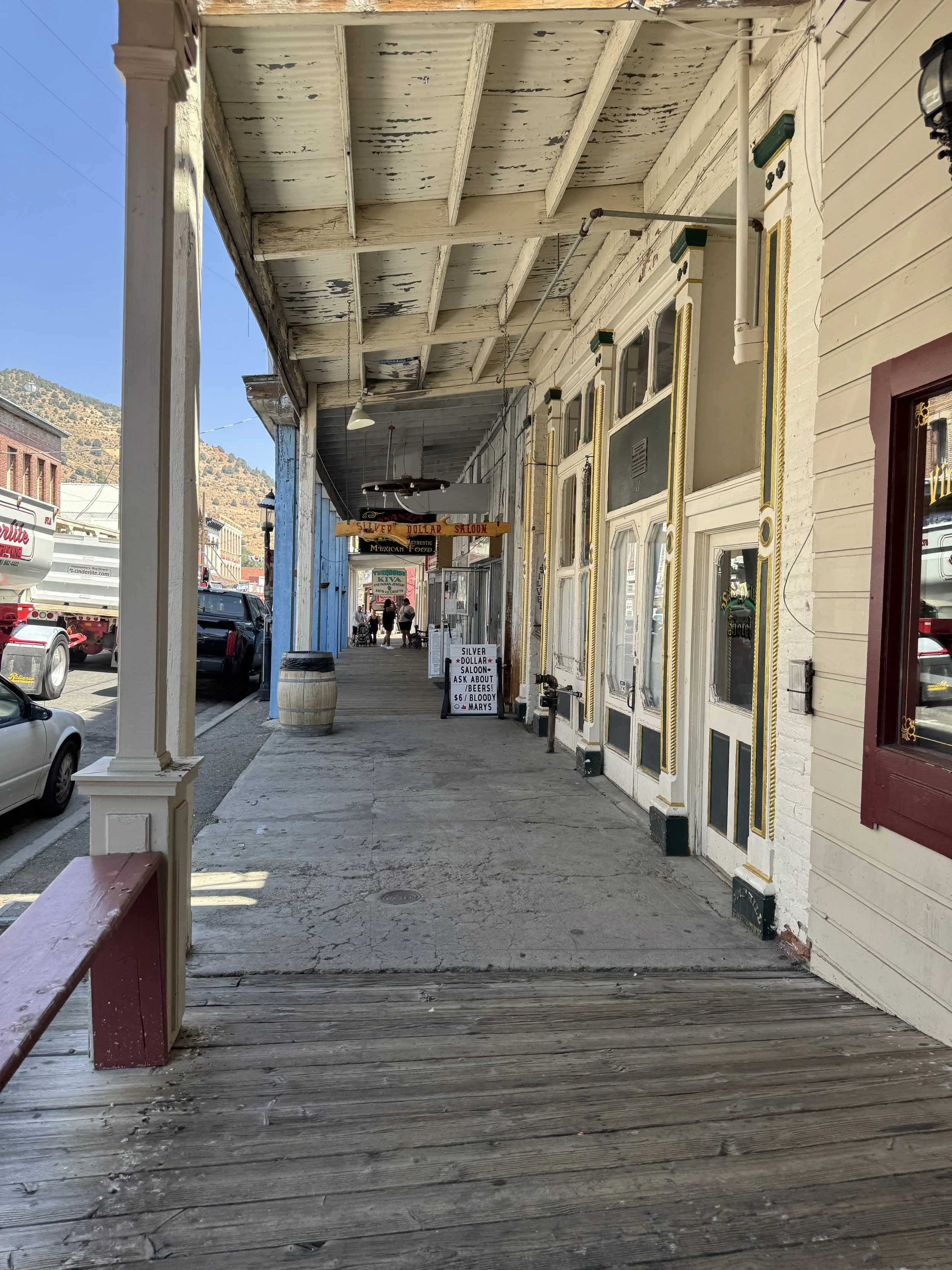 Weathered wooden sidewalk and historic storefronts along Virginia City’s main street in Nevada.