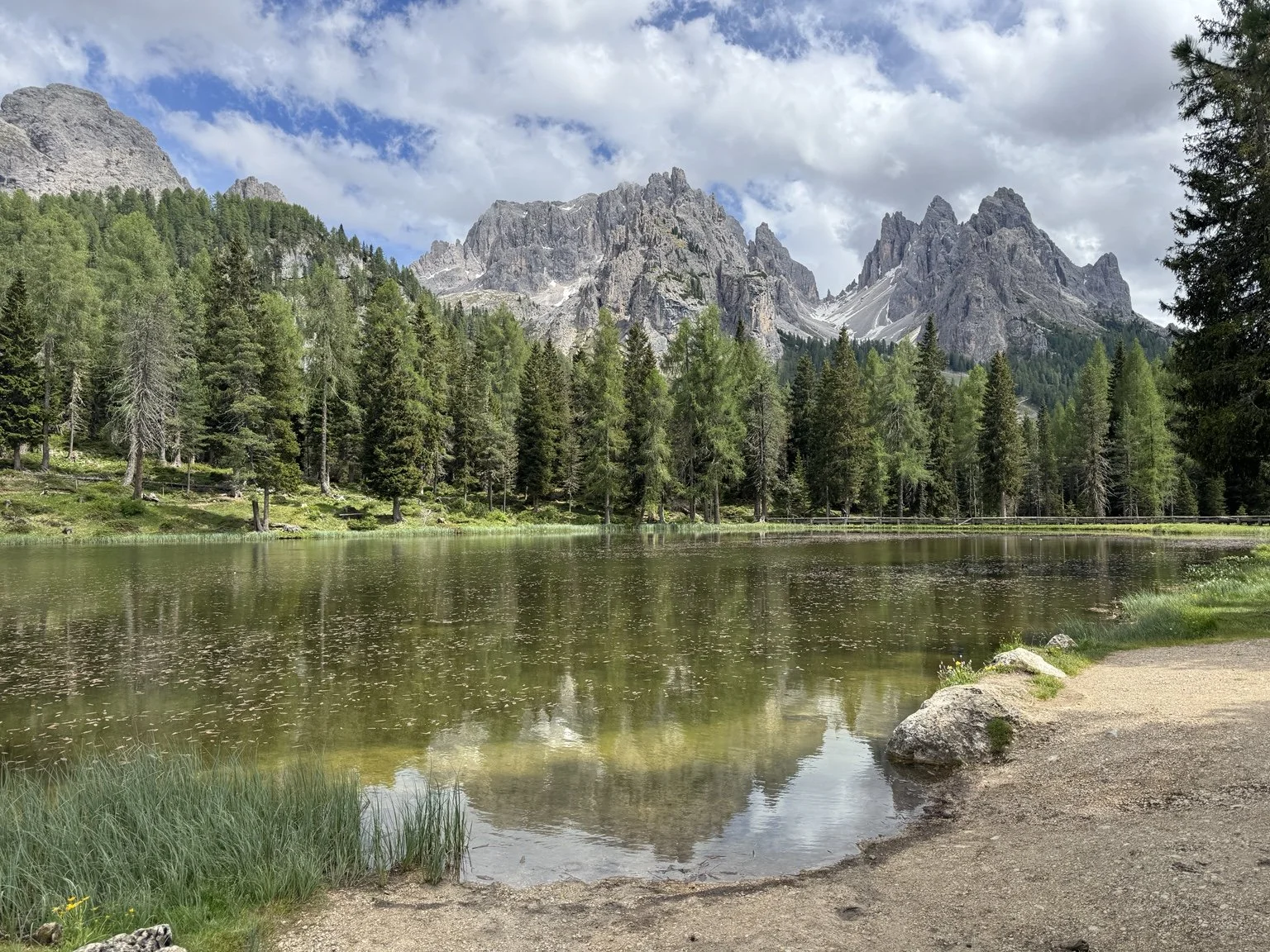 Jagged Dolomite peaks reflected in the calm water of Lago d’Antorno.