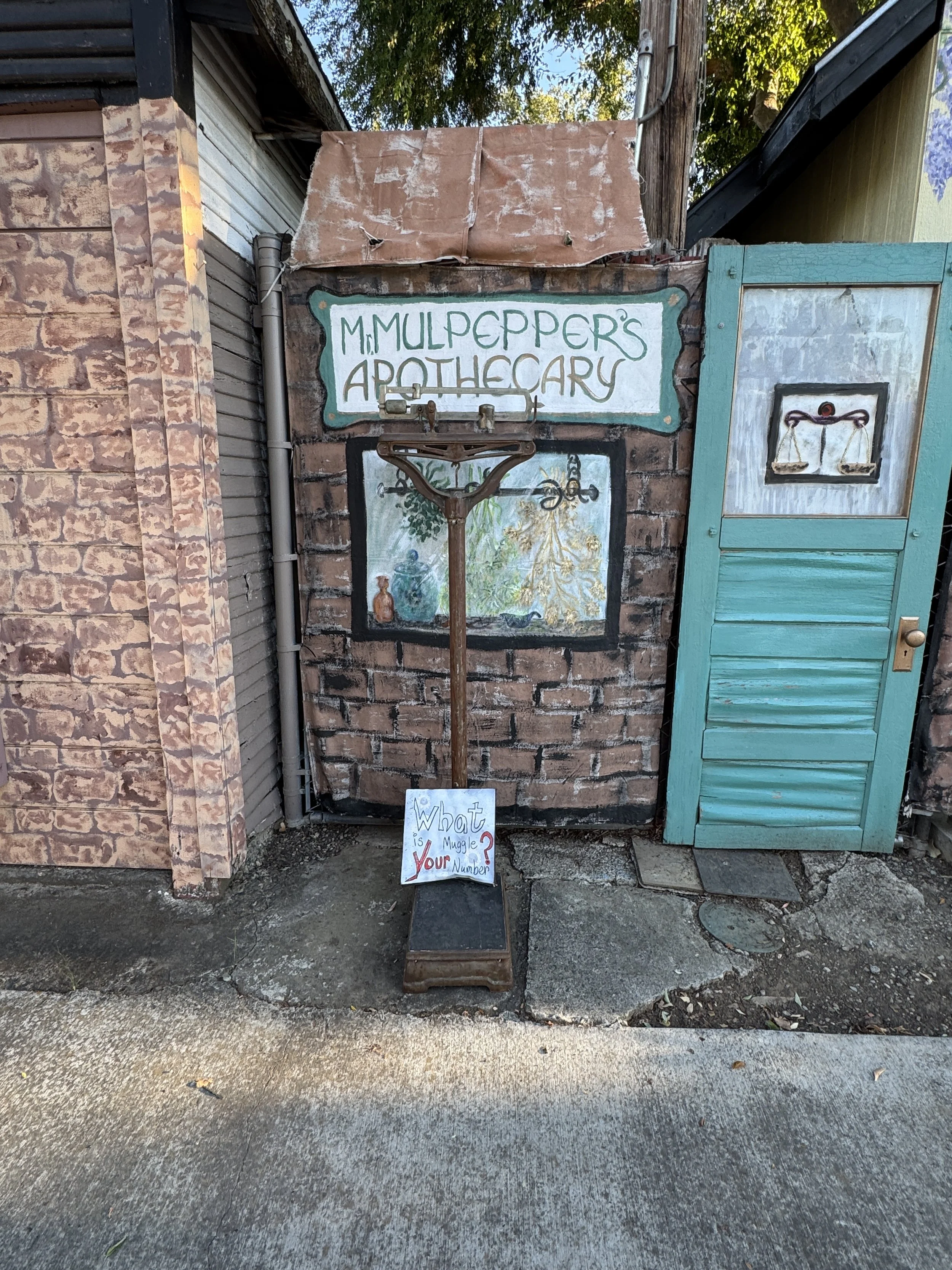 Hand-painted M. Mulpepper’s Apothecary storefront with a turquoise door in Sacramento’s Diagon Alley.