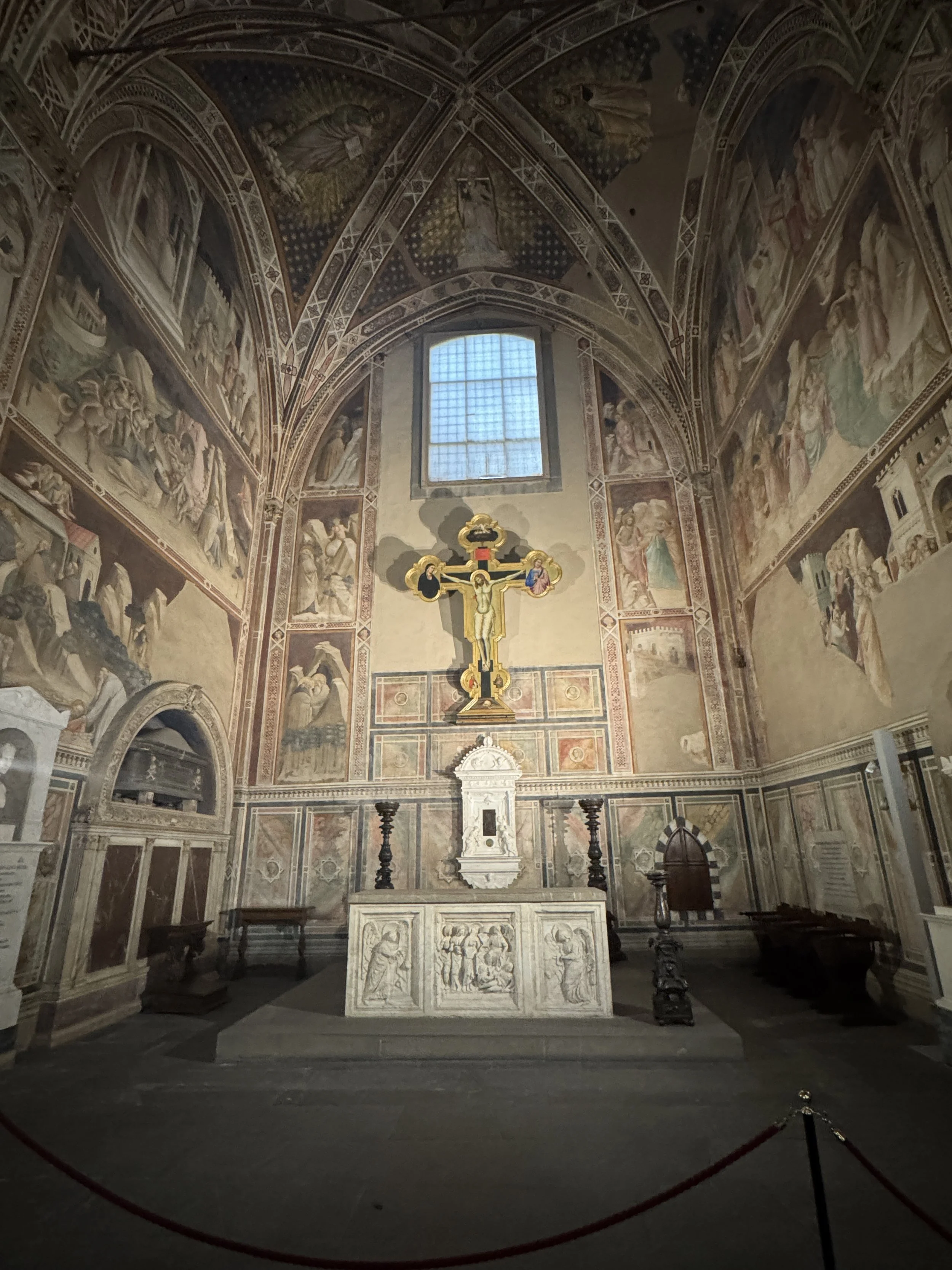 Frescoed chapel and painted crucifix inside the Basilica di Santa Croce.