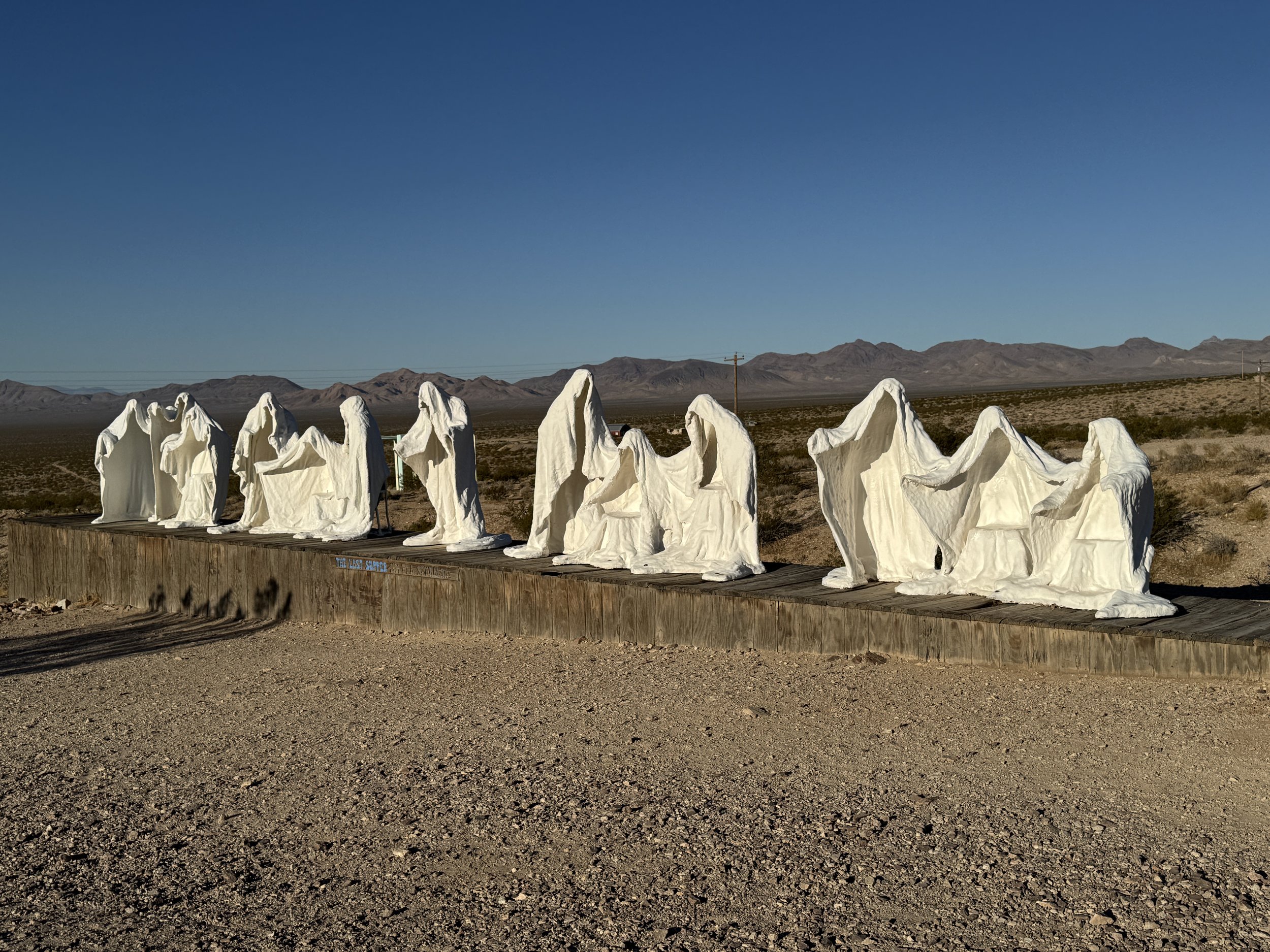 White ghostly figures of The Last Supper installation at the Goldwell Open Air Museum in the Nevada desert.