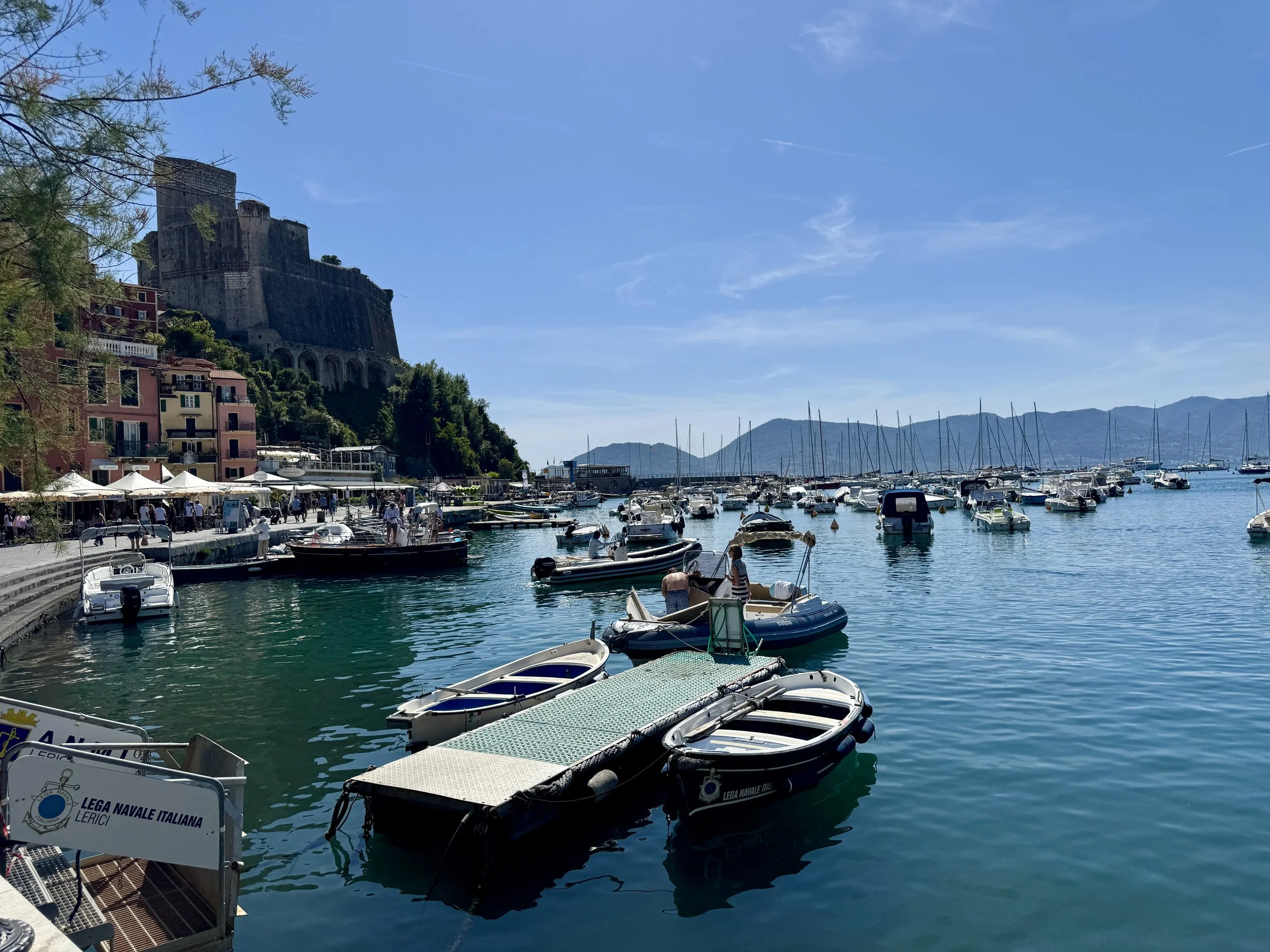 Boats in Lerici harbor beneath the castle
