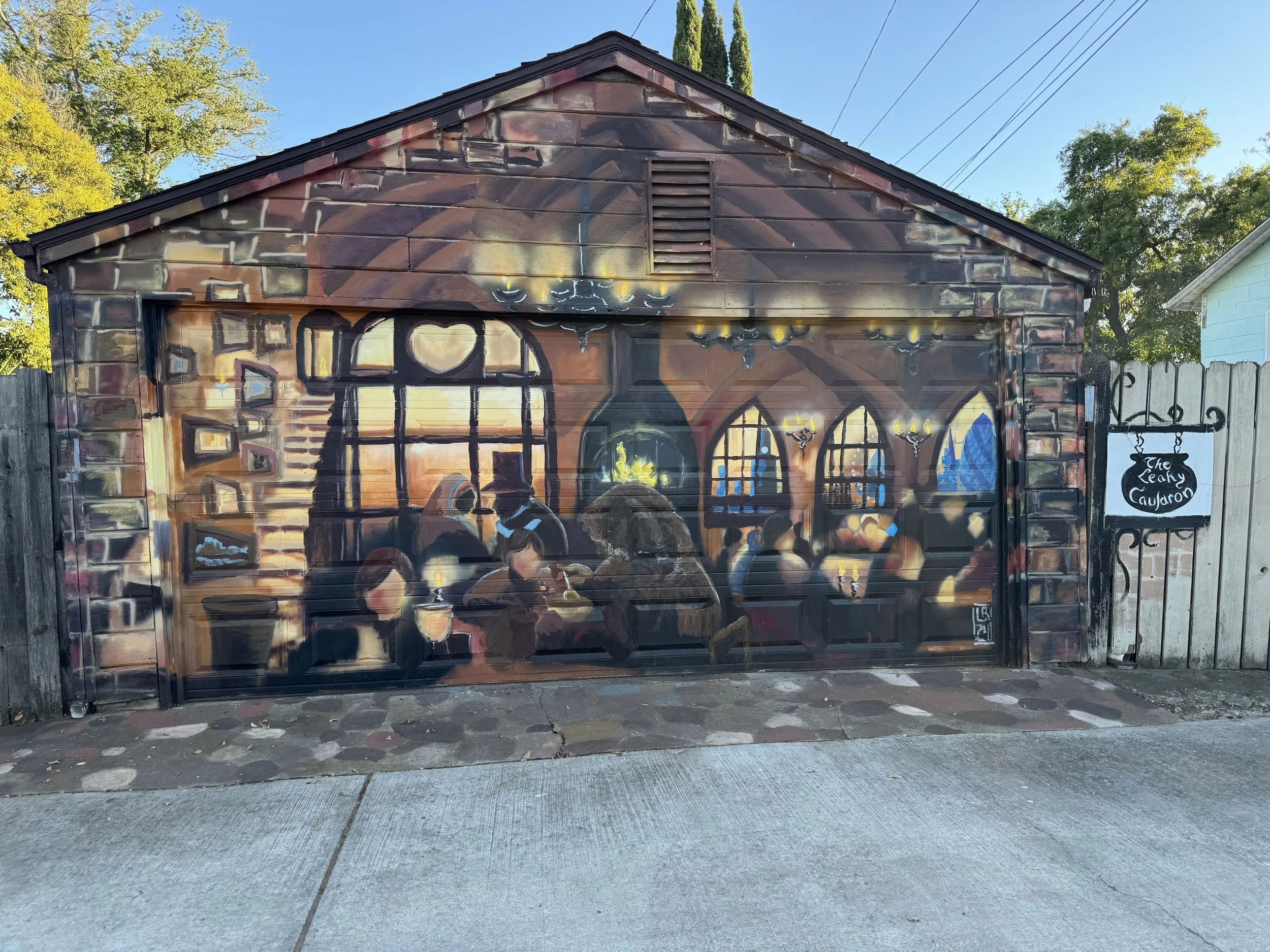 Harry Potter-themed Leaky Cauldron mural painted across a garage door in Sacramento’s Diagon Alley.