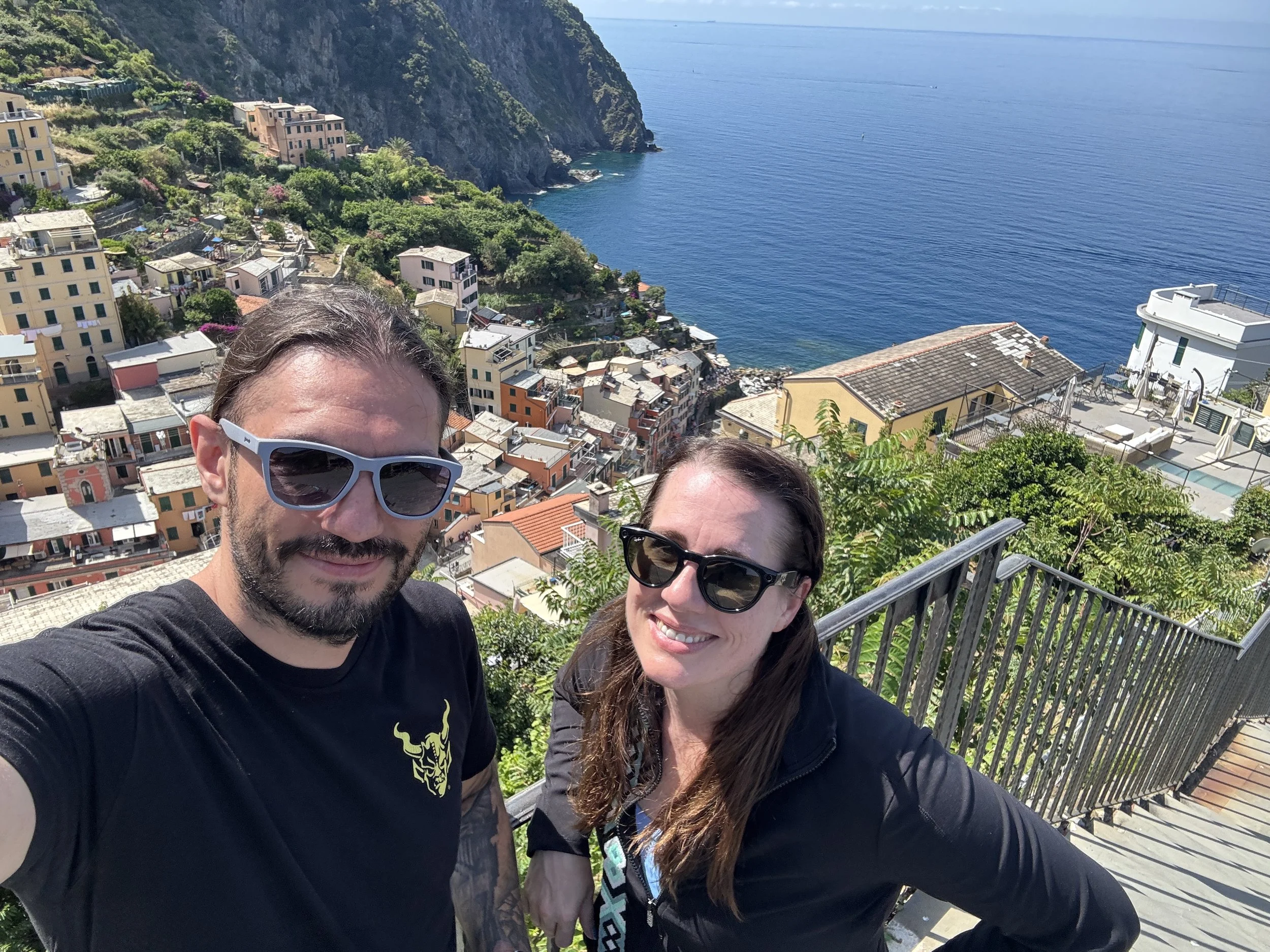 Couple overlooking Riomaggiore and the Ligurian Sea