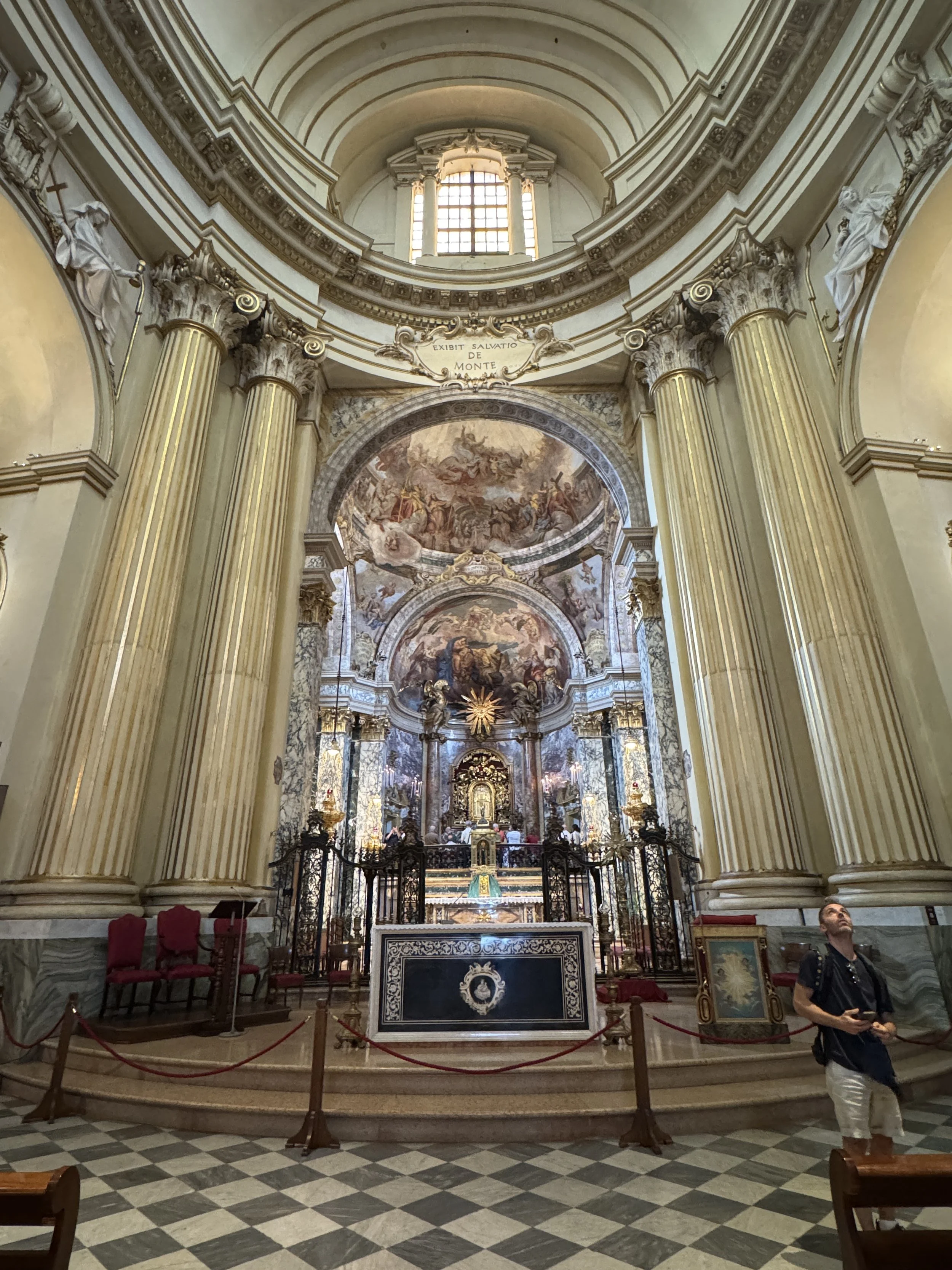 Ornate main altar and frescoes inside Bologna's Sanctuary of the Madonna di San Luca.