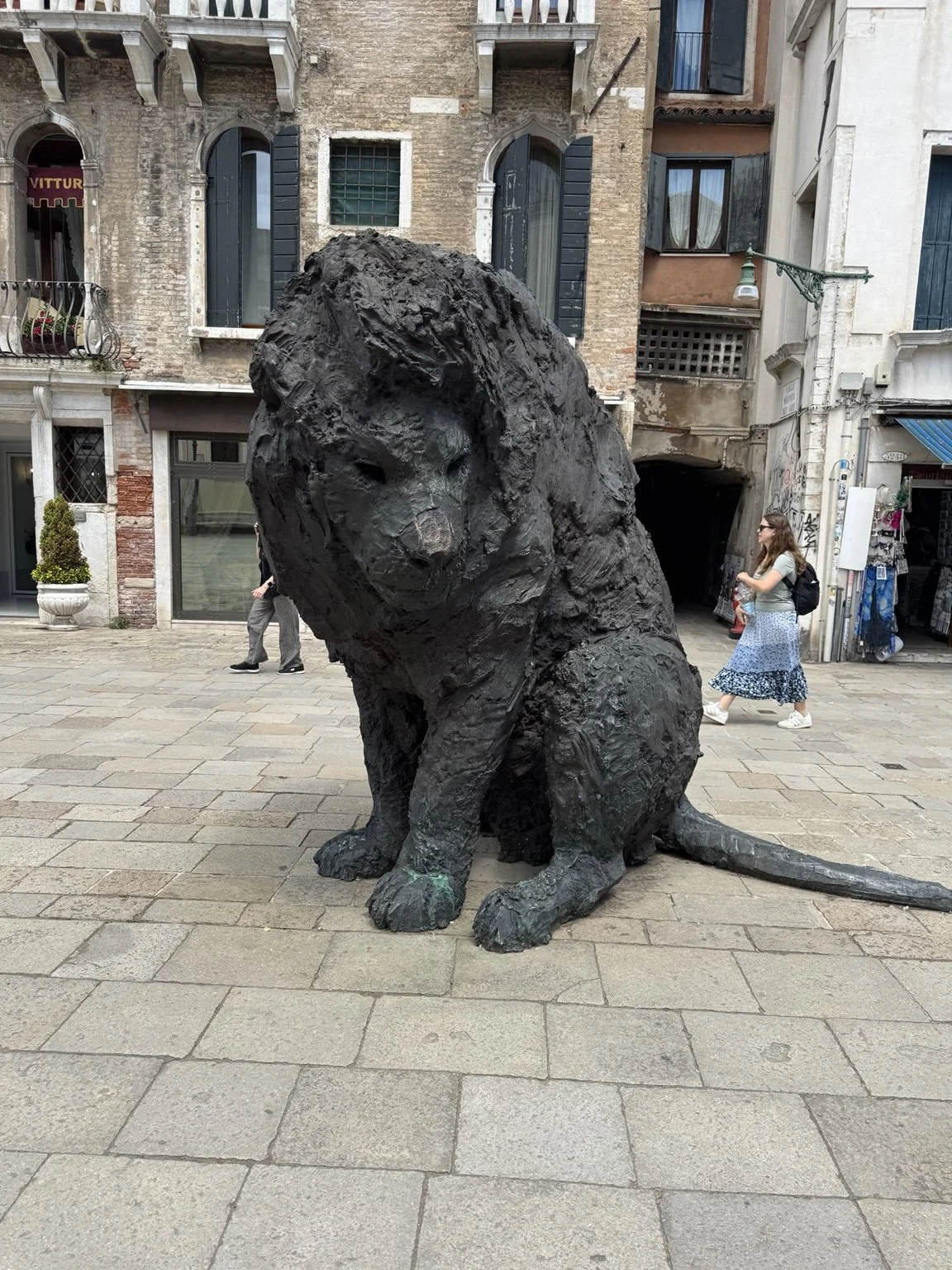 Large bronze lion sculpture in a Venetian square near Campo dei Mori.