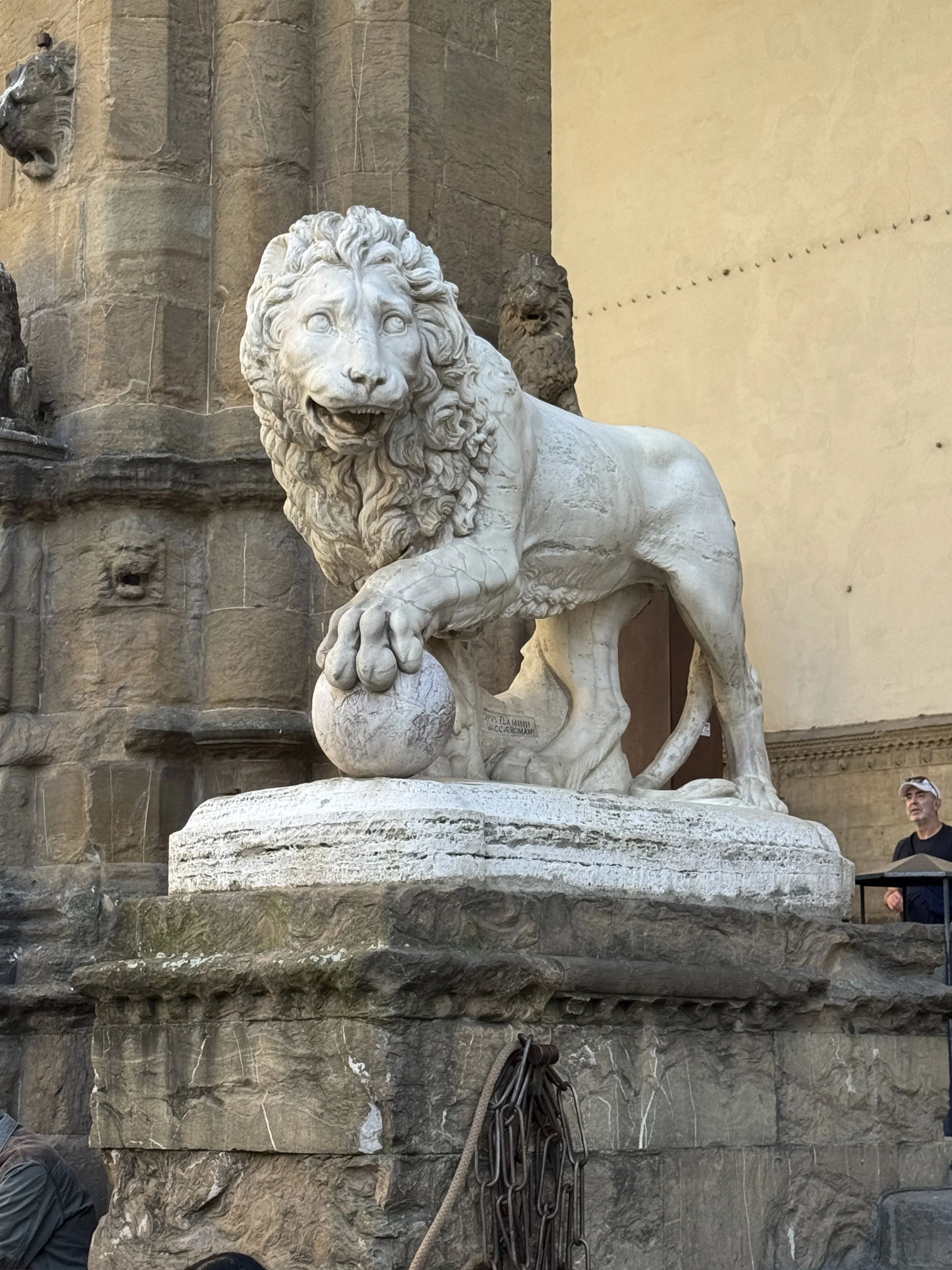 Historic lion sculpture on a stone pedestal in Florence.