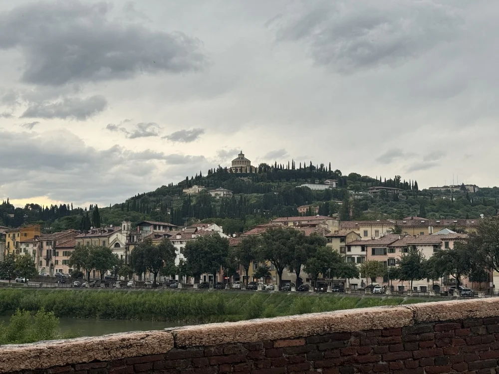 View across the Adige River toward Castel San Pietro from Ponte Pietra in Verona